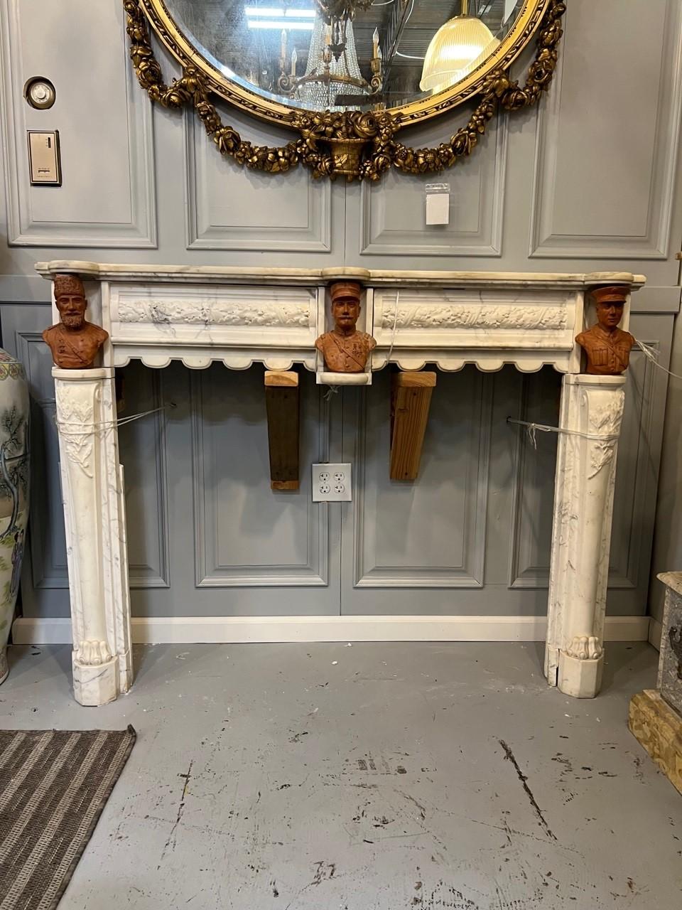 Amazing antique white Carrara marble fireplace mantel with three incredible terracotta busts, very unique and maybe one of a kind. The bust on the left looks to be a military leader or Russian Ruler. The center bust looks like a leader from France