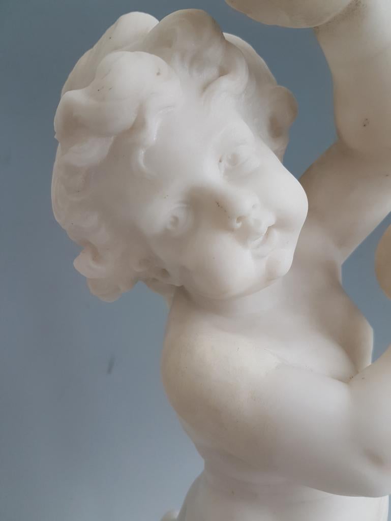 A fine and good size Carrara marble sculpture of a dancing putti, playing cymbals, after a design by Clodion. A finely carved piece, set upon a red griotte marble base, with a ring of gilt bronze beading. Very good quality, excellent detail to the