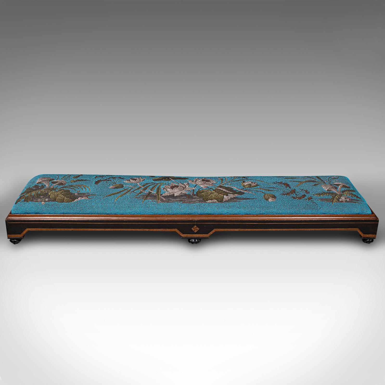 This is an antique carriage foot rest. An English, mahogany and boxwood beadwork cushion stool, dating to the late Victorian Aesthetic period, circa 1890.

Delightfully eye-catching stool with generous proportion
Displays a desirable aged patina and