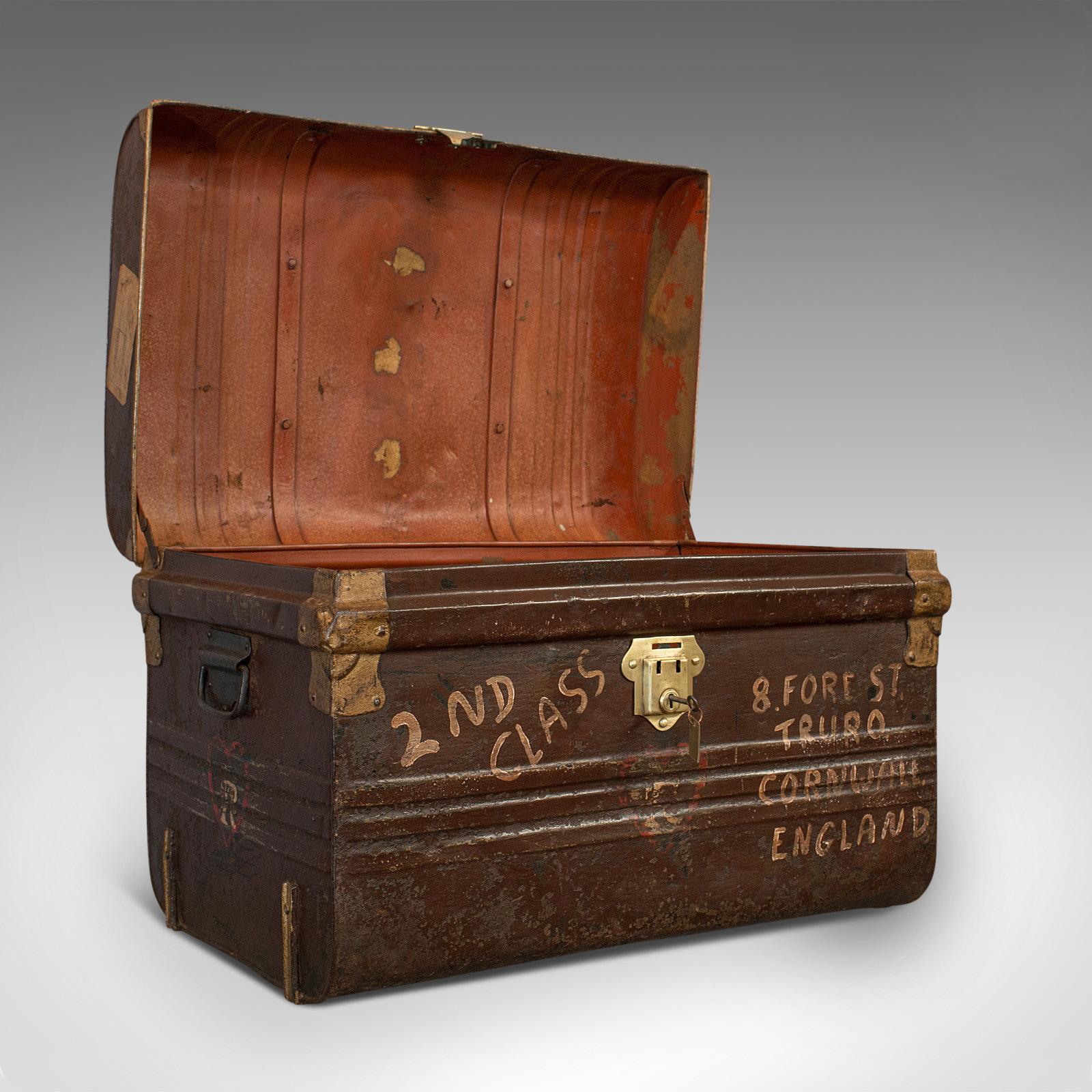 This is an antique carriage trunk. An English, steel railway or steamer chest, dating to the late Victorian period, circa 1900.

Abundant period detail
Displays a desirable aged patina
Painted steel in good order throughout
Brass shoulders and