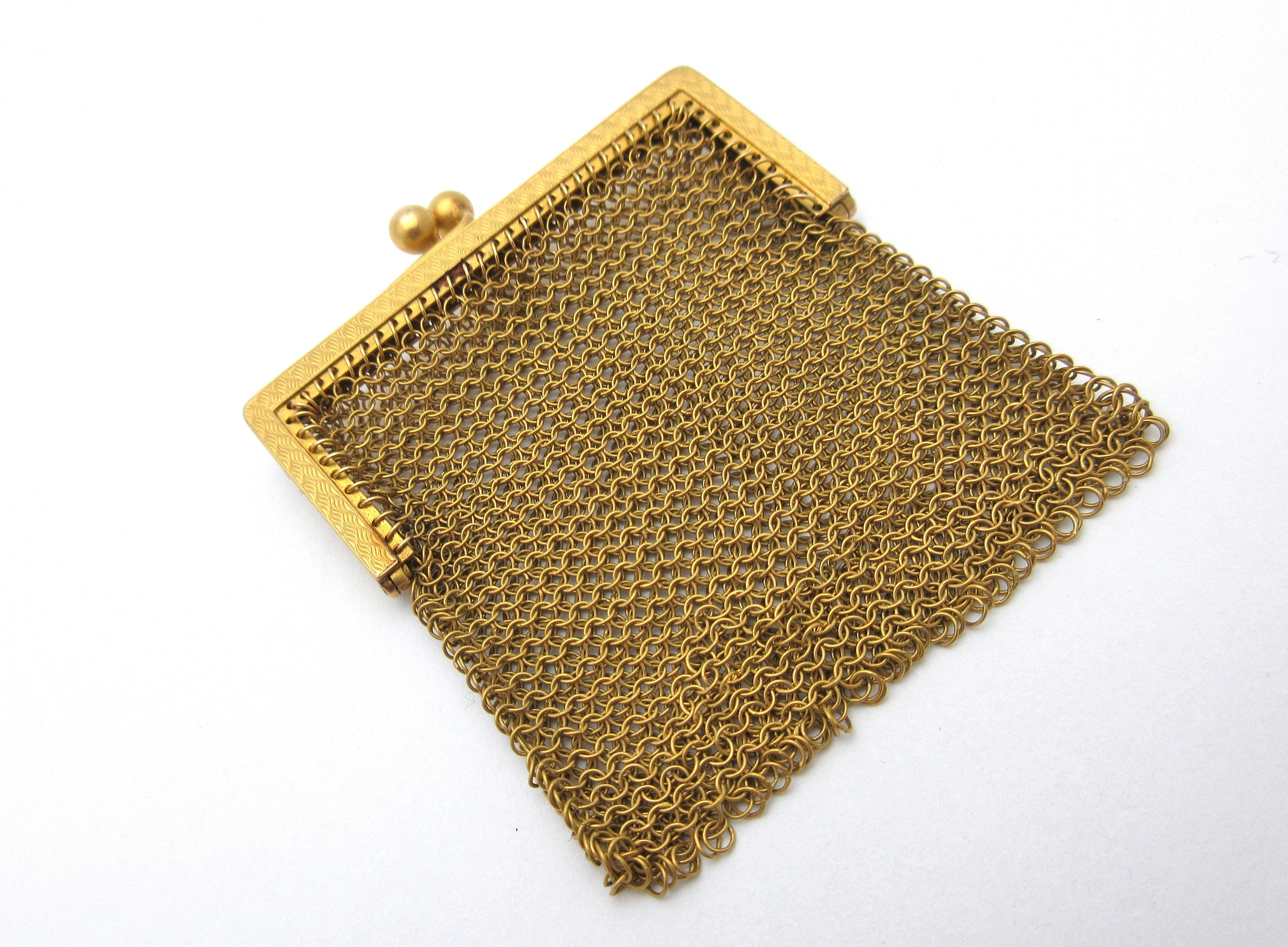 This beautiful little mesh purse was likely worn on a woman's chatelaine during the turn of the 20th century.  It was made from 14k yellow gold by Carter, Gough, & Co (in business from 1841-1922) in Newark, NJ.  The coin purse features a patterned