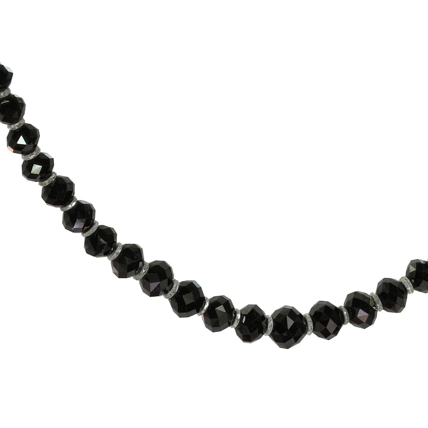 This exquisite necklace features a single strand of sparkling black diamond faceted beads each spaced by rare white briolette-cut diamonds roundels measuring between 4.40mm and 7.40mm. The necklace is completed with a antique CARTIER platinum clasp