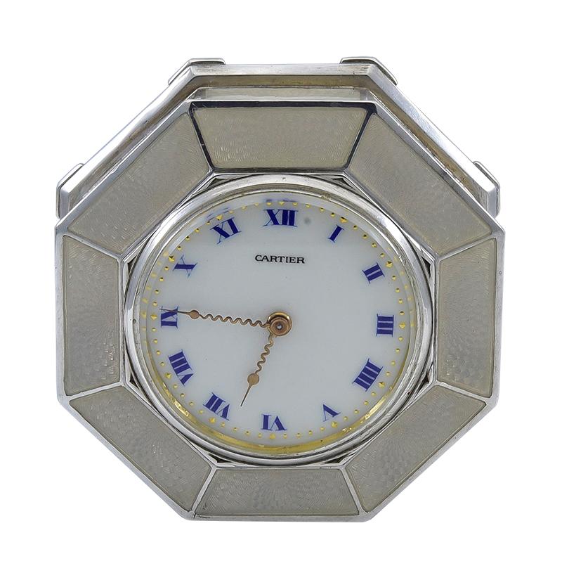 Luminous silvery white guilloche enamel miniature desk clock.  Made and signed by CARTIER Paris.  Enamel dial, with blue numerals and gold accents.  Gold hands.  Octagonal shape.  2 1/3