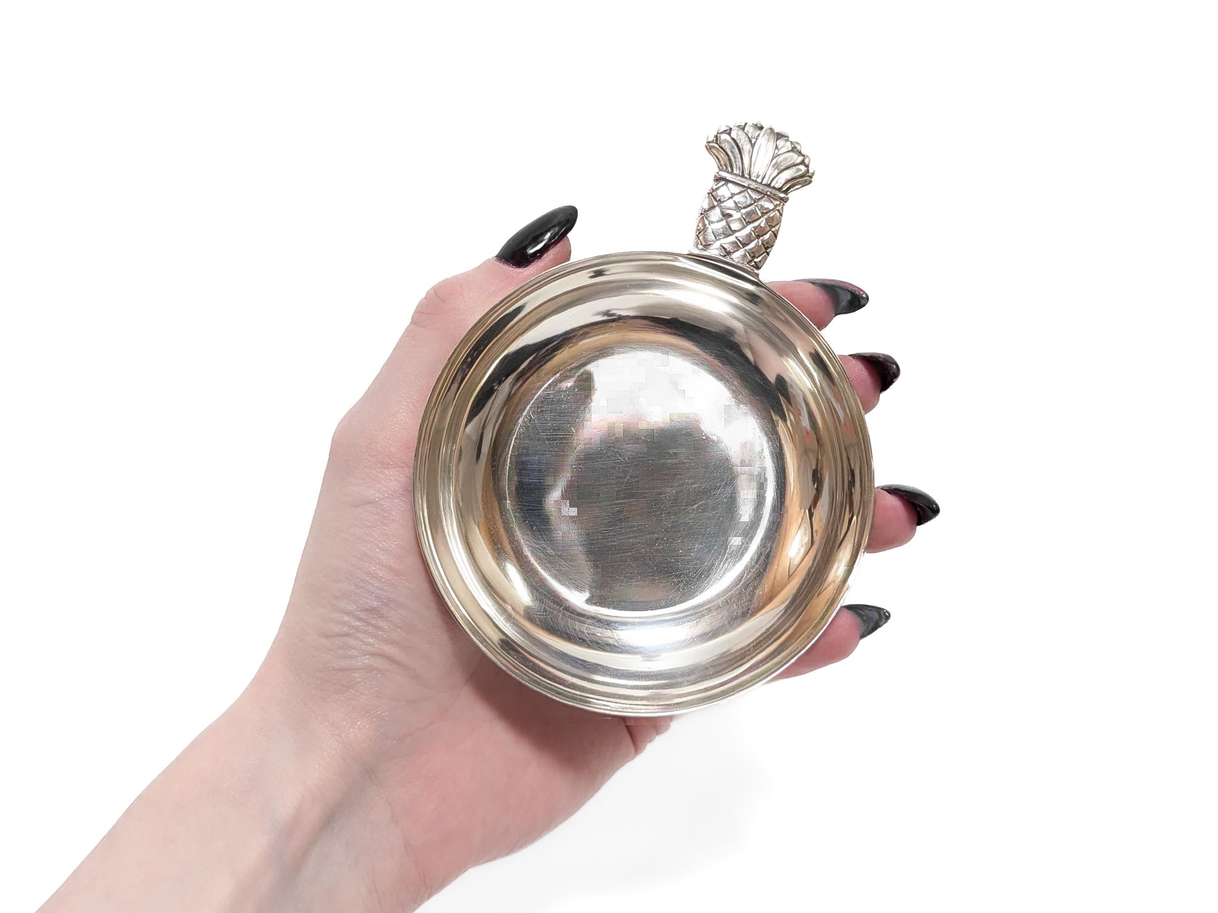 A fine signed silver tastevin or wine tasting cup. 

Made by Old Newbury Crafters for Cartier.

In sterling silver.

With a stylized pineapple handle.

Marked to the base.

Simply a wonderful Cartier tastevin!

Date: 
Mid-20th Century

Overall