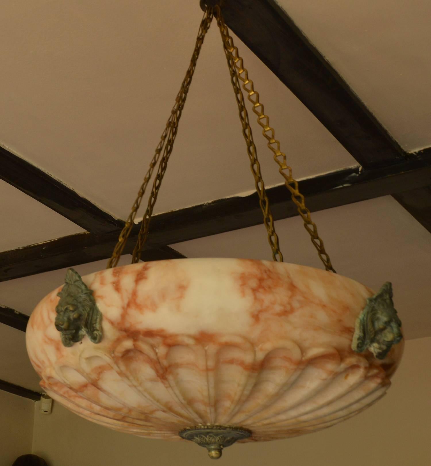 Fabulous carved alabaster chandelier.

Wonderful gadrooning and grain in the alabaster.

I particularly like the original gilt brass lion mask hardware.

The measurements given below relate to the alabaster part. These particular chains