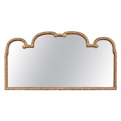 Antique Carved and Gilt Beveled Mirror with Regal Form