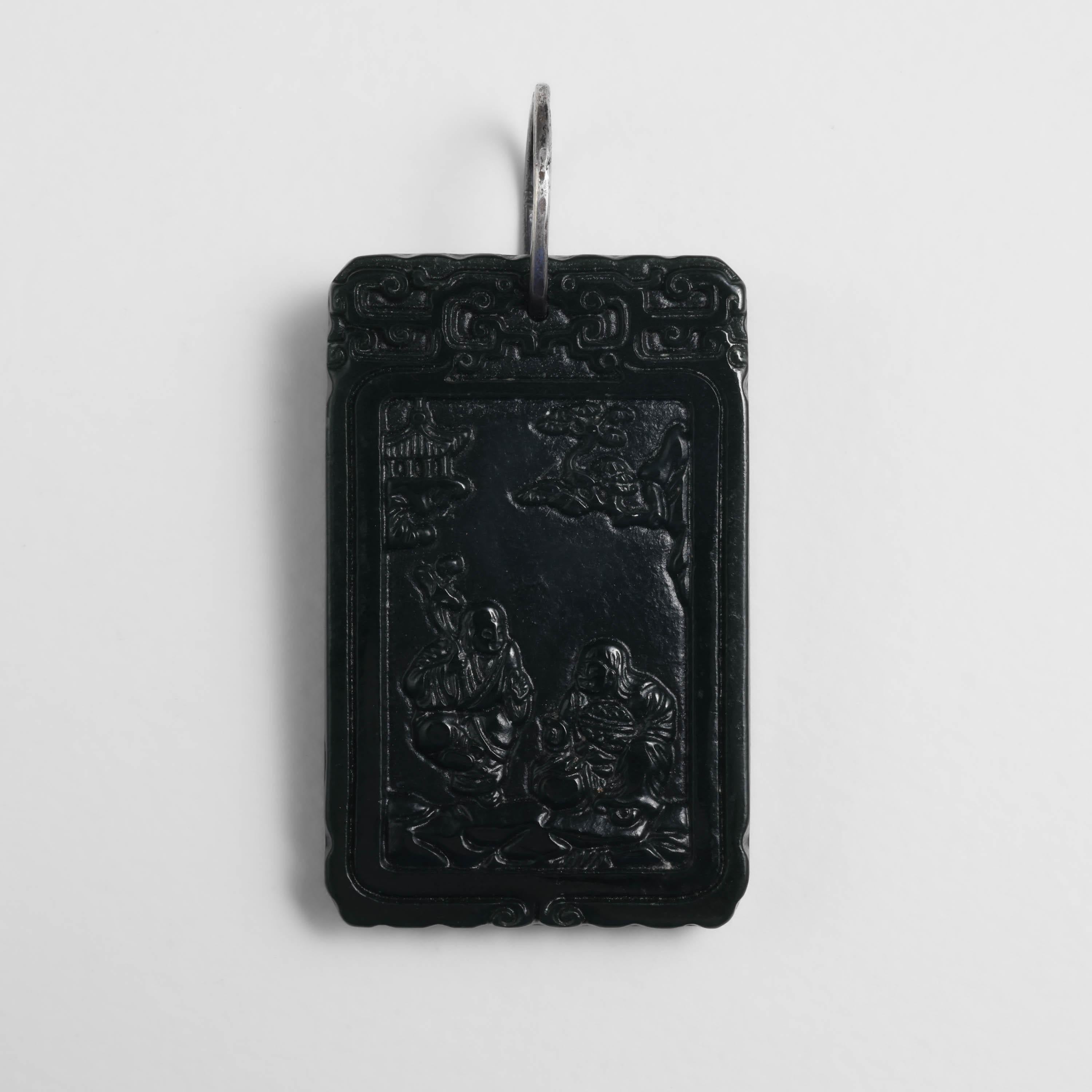 This exquisite and rare black jade tablet dates to the Qing period. 

The Qing Dynasty period spanned the years 1636 -1912. Precisely dating jade artifacts from this era is an imprecise science. Part of the reason for this is because lapidary