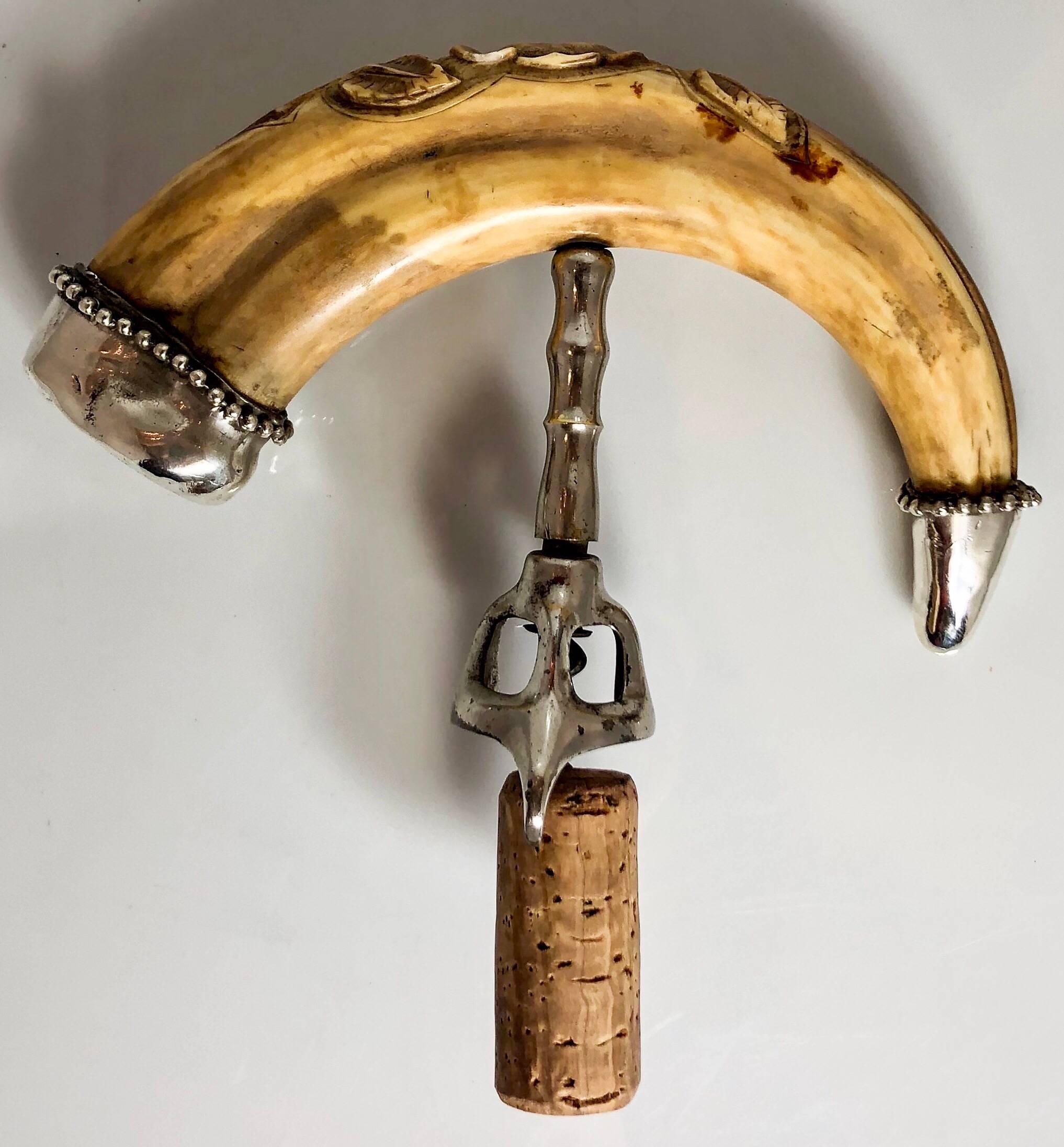 Antique carved boar's tusk corkscrew with sterling silver mounts, circa 1880-1890.