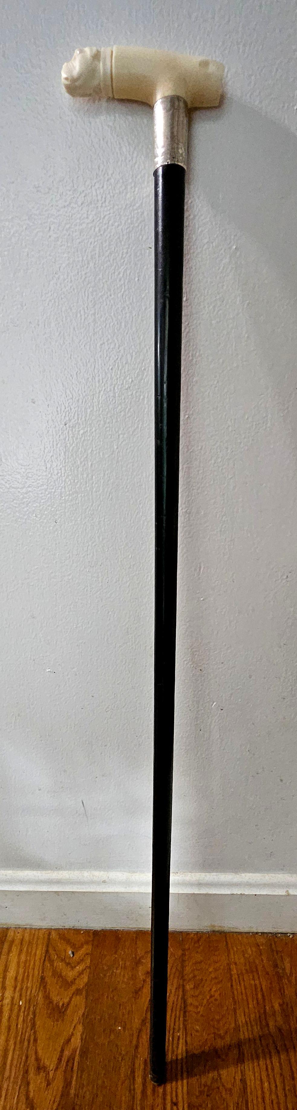 Antique English carved bone bulldog-handled cane with sterling collar, hallmarks of Birmingham 1918/19, maker JH. Has presentation and date of 19-1. 
Ebony shaft 35.5 in long. Head: 4.5