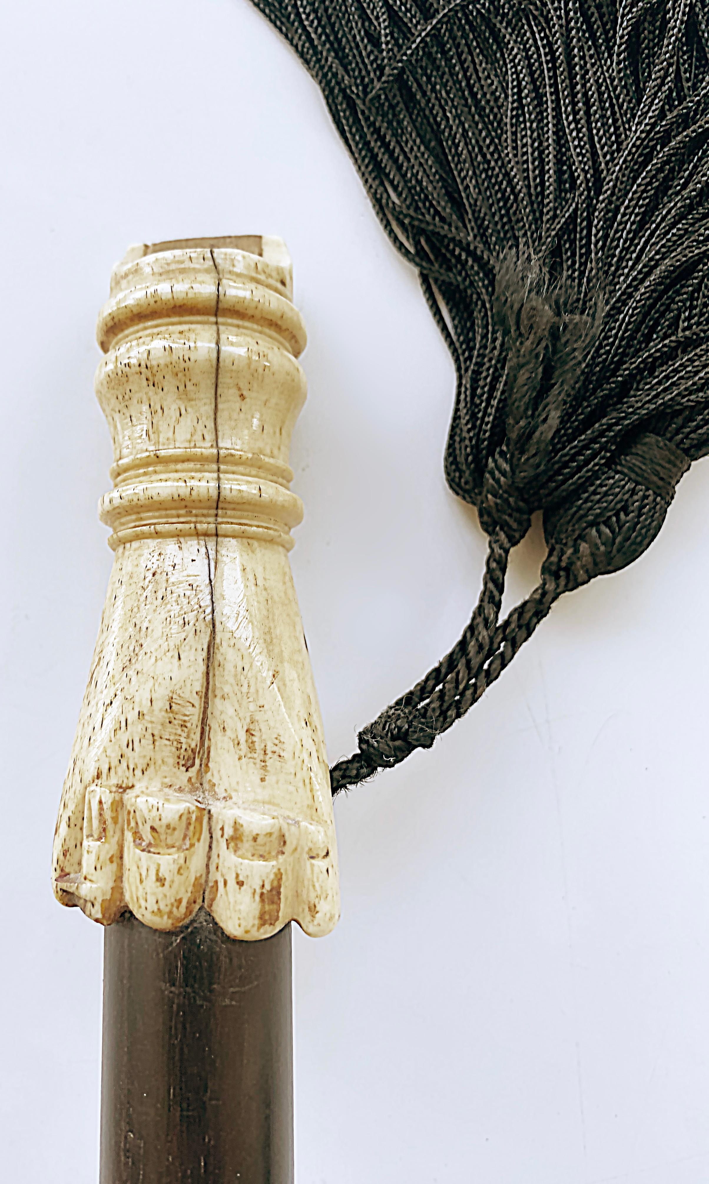 Antique Carved Bone Hand Whistle Walking Stick Cane.

Offered for sale is an antique bone-handled walking stick that has a carved hand for the handle that is a whistle. The carved hand sits atop an ebonized wood stick. The tip end of the stick is