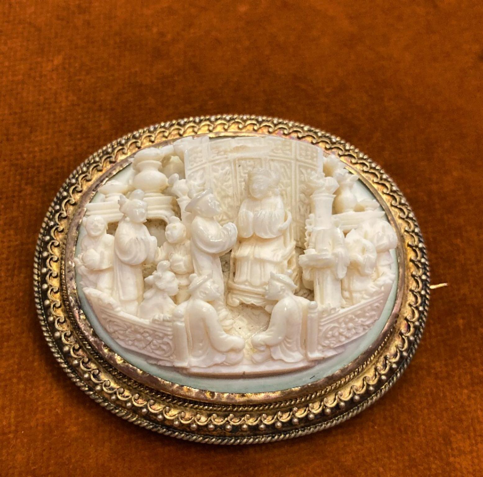 An antique nineteenth century carved bone and yellow gold brooch-pendant depicting an Eastern scene.