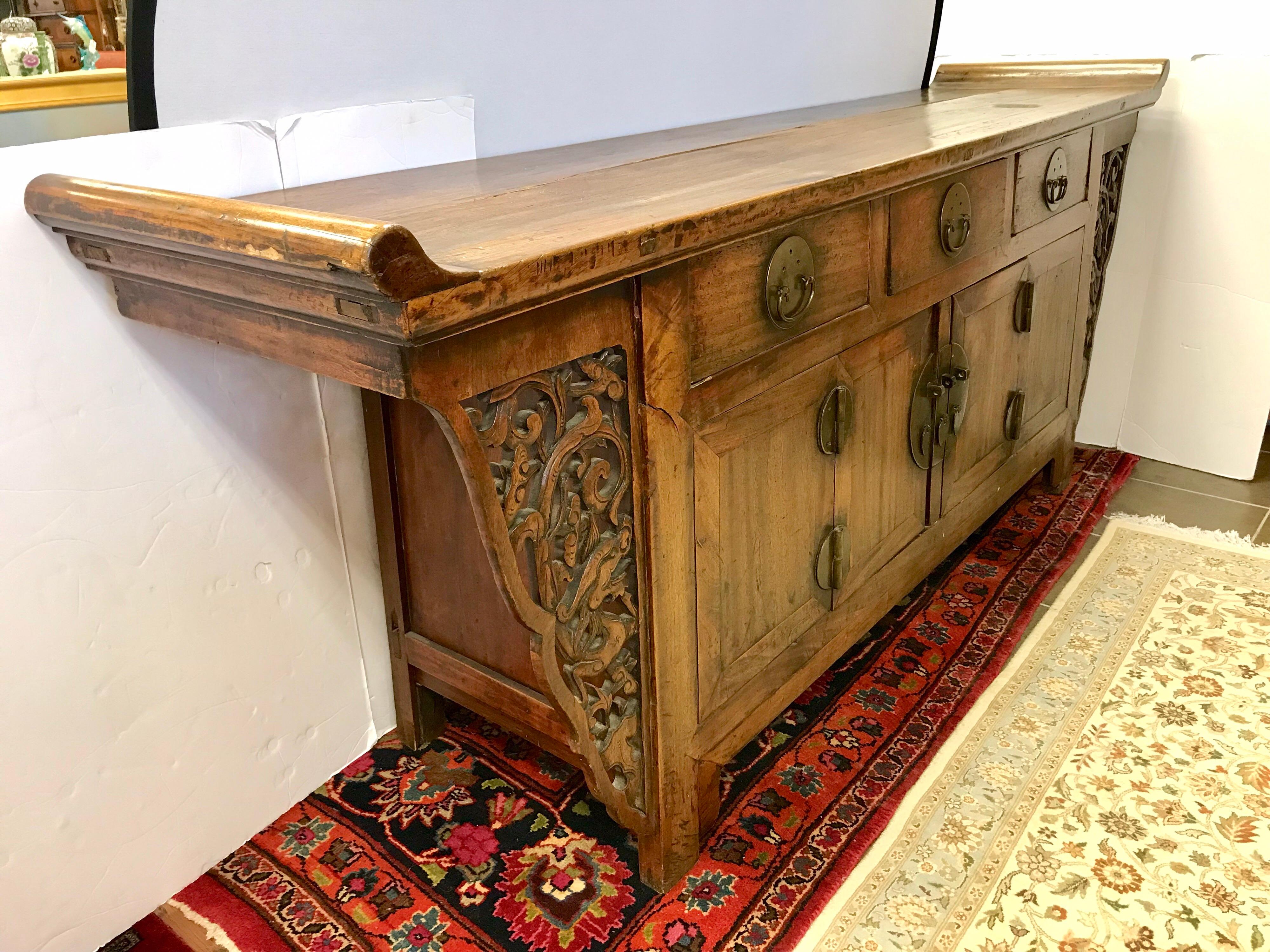Intricately carved Chinese altar table with plenty of storage below.