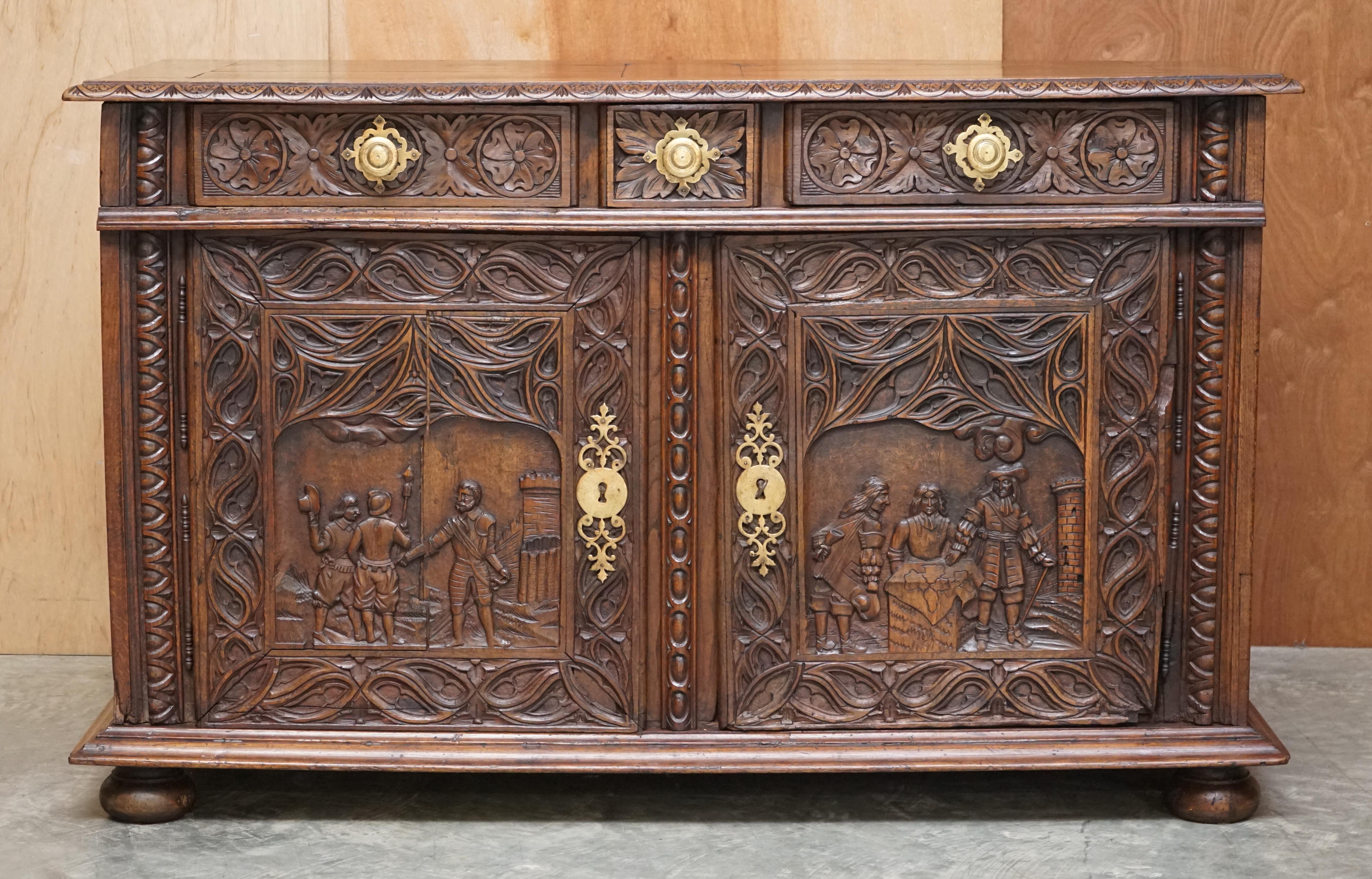 We are delighted to offer this lovely hand carved continental oak sideboard with militaria style front panels 

An expertly crafted piece, this is pure art furniture and looks amazing from every angle. Its continental, most likely Austrian or