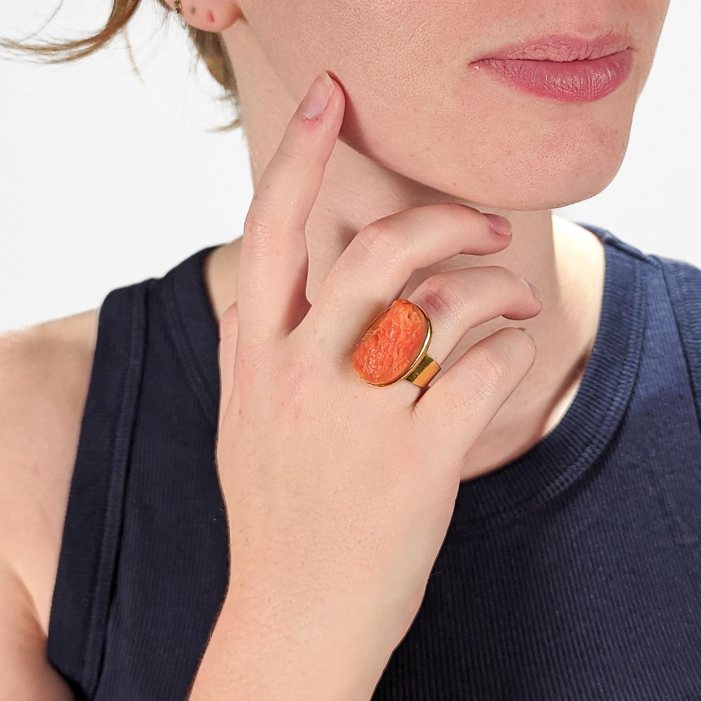 A fine antique carved cameo ring.

In 14 karat yellow gold.

Bezel-set with a carved coral cameo in high relief supported by a wide tapered shank. 

The cameo depicts what appears to be a Renaissance figure - a bearded man resembling Leonardo da