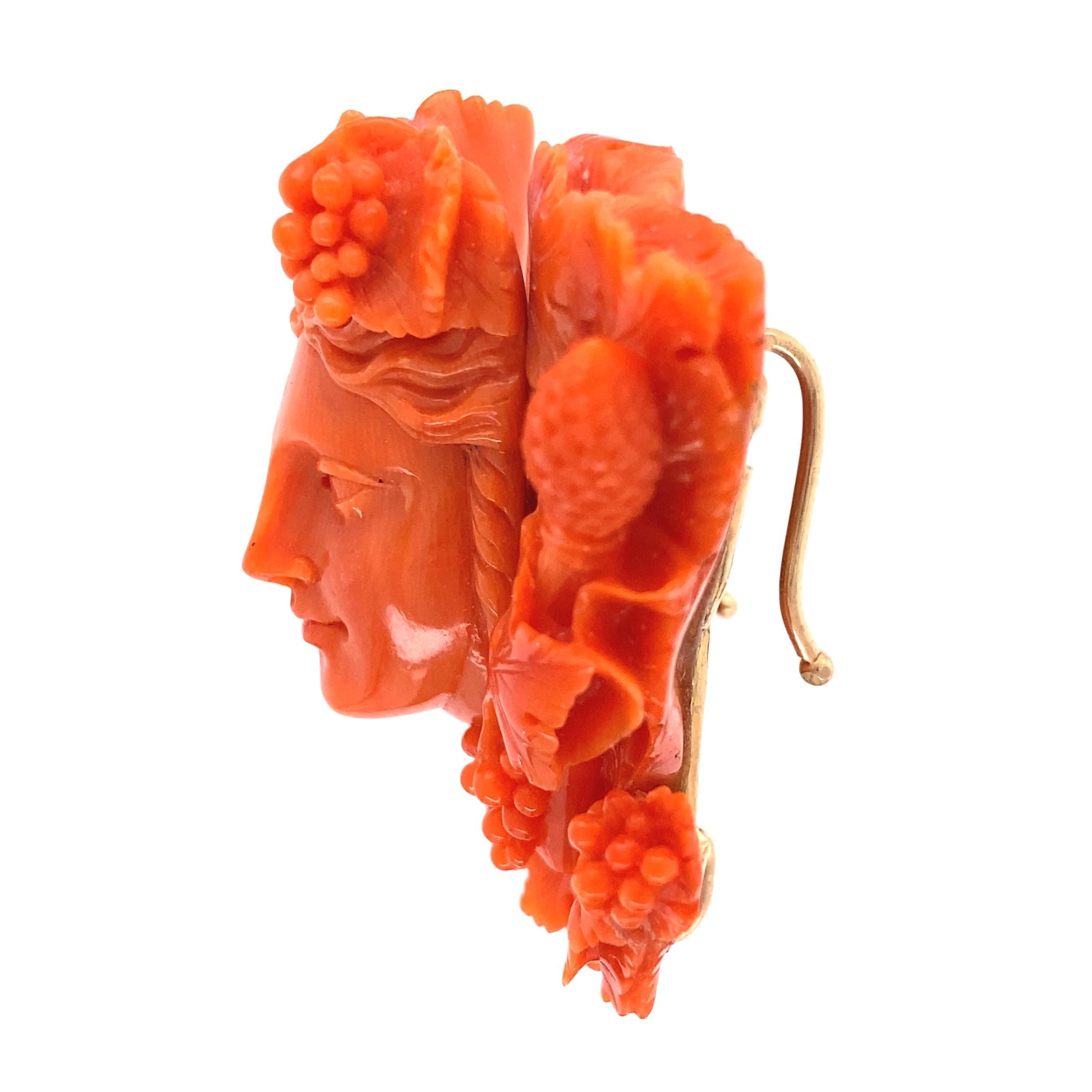 Beautiful and Stylish Antique Victorian Carved Coral and Gold Pendant Enhancer featuring a Noble face with Flowers & Fruit depicting Bacchus. Skillfully Hand crafted. Approx. dimensions: 2”w x 1.75”h x 0.79”d. Classic and Stylish…A Perfect