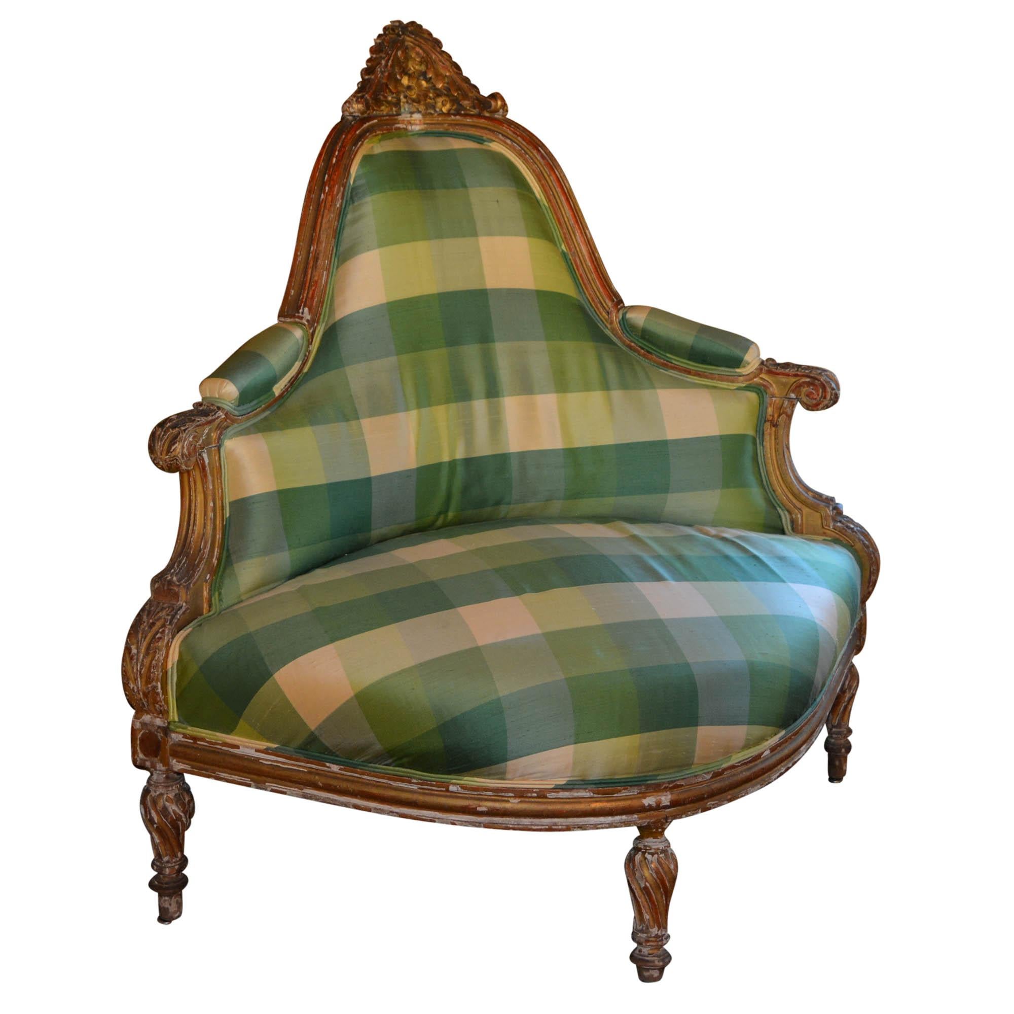 This stunning antique corner chair has been reupholstered in a high quality silk by David Franklin. The aged gold frame is matched beautifully with tones of soft greens and cream in a wide plaid. It is rare to find an antique corner chair with such