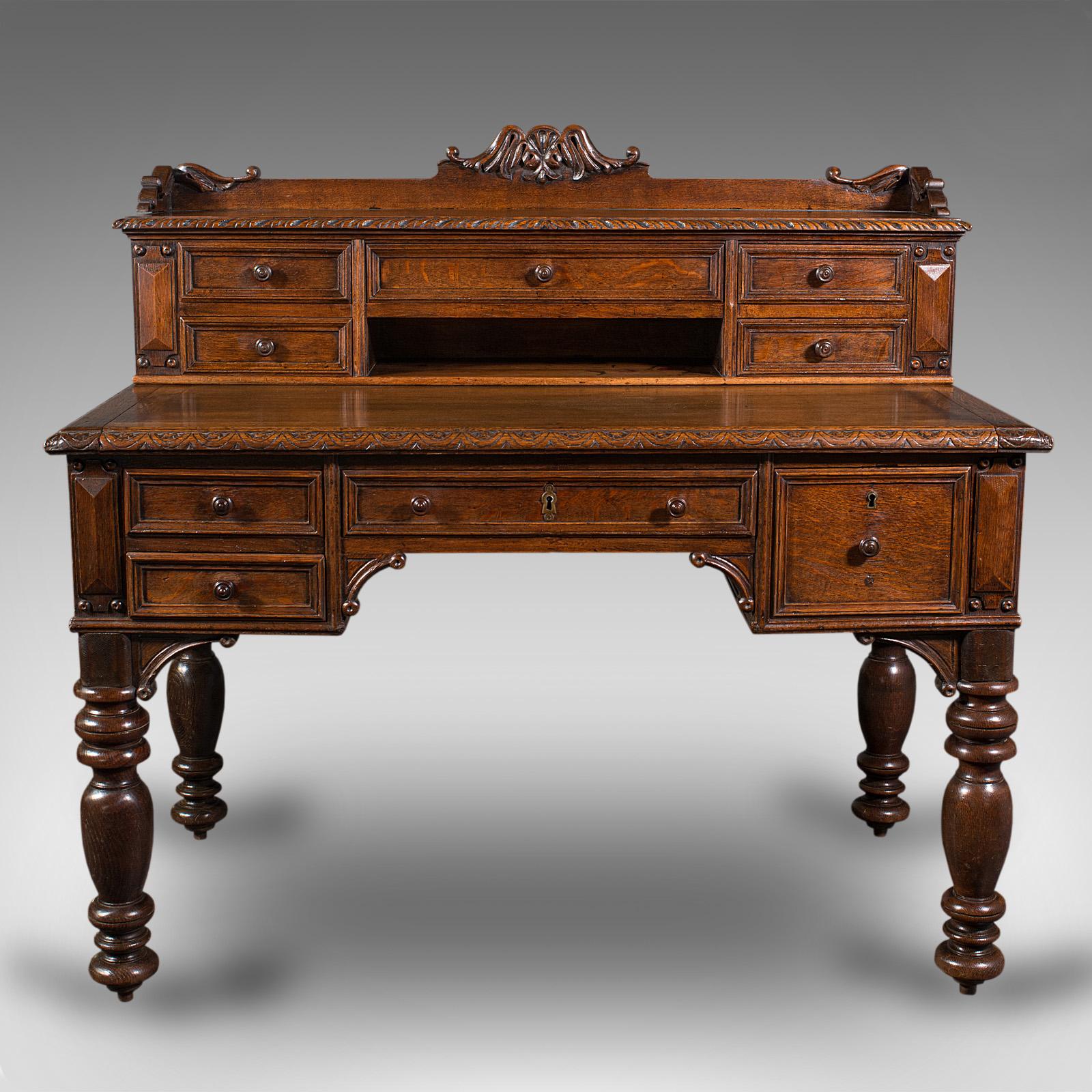 This is an antique carved correspondence desk with hidden drawer. A Scottish, oak writing table, dating to the early Victorian period, circa 1860.

Superior quality desk with delightfully figured stocks and Gothic revival overtones
Displays a