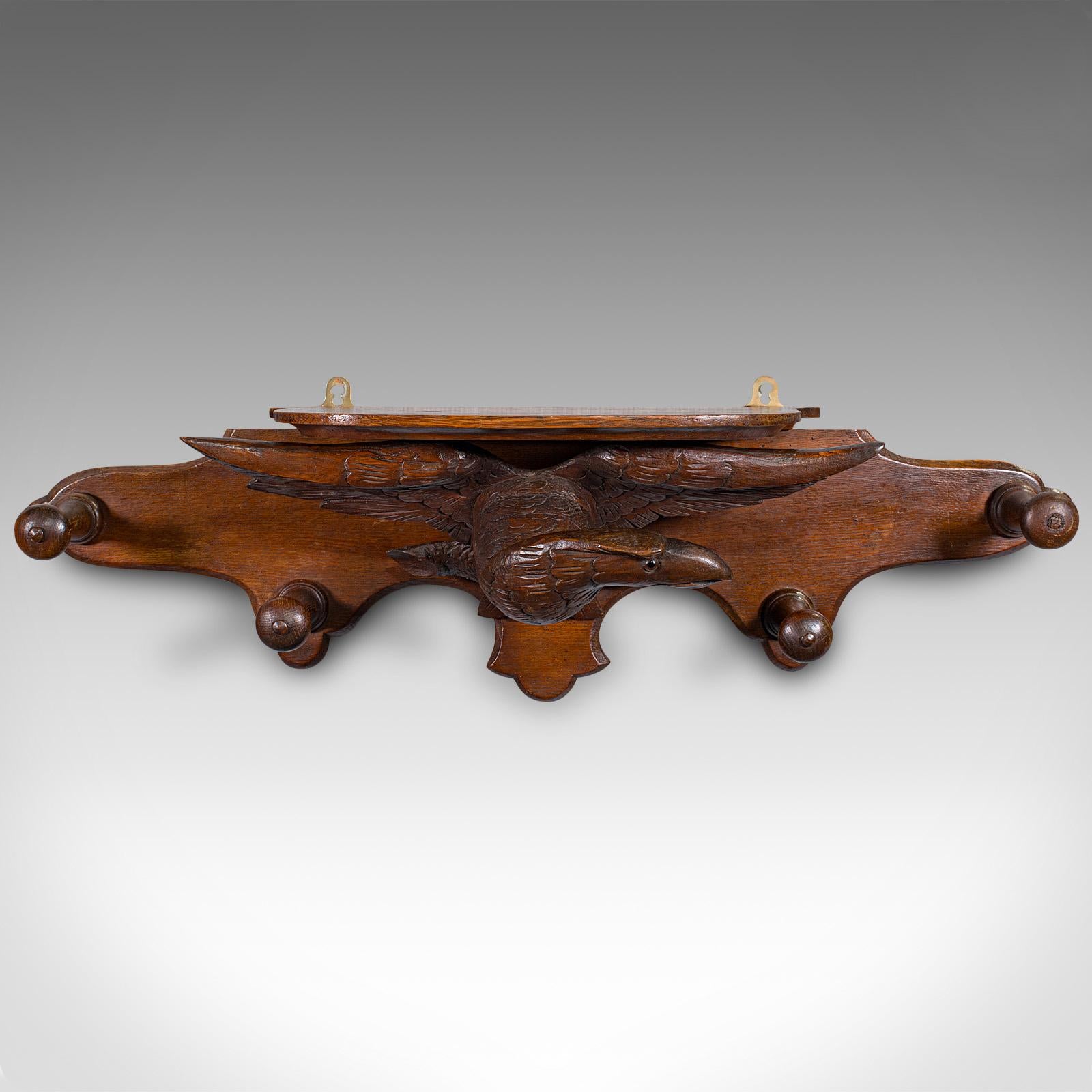 
This is an antique carved eagle coat rack. A Scottish, oak hallway peg mount, dating to the late Victorian period, circa 1900.

Superb eagle decor accentuates this fine hallway rack
Displaying a desirable aged patina and in very good order
Scottish