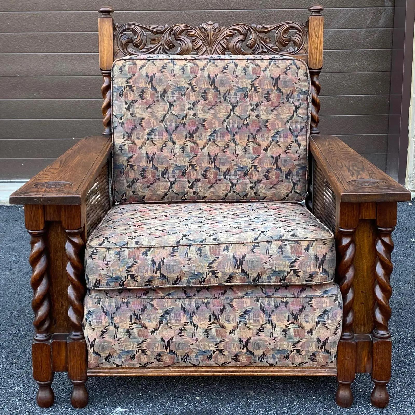 A unique hand carved oak lounge chair with caned sides and back and barley twist columns. Originally on six casters which are not included. 