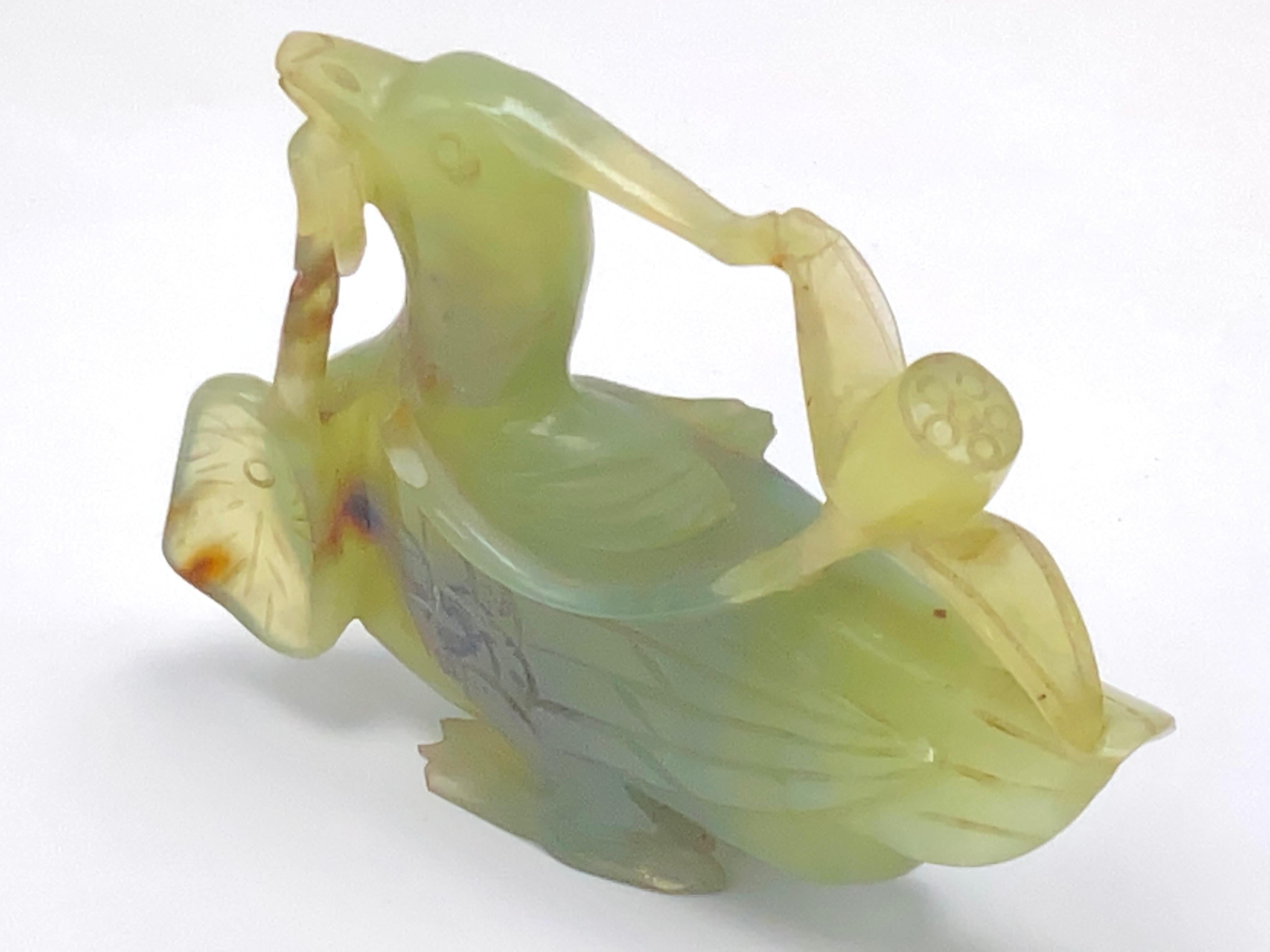 This bird is in Jade. It has been made in China during the 20th Century.
The color is green.