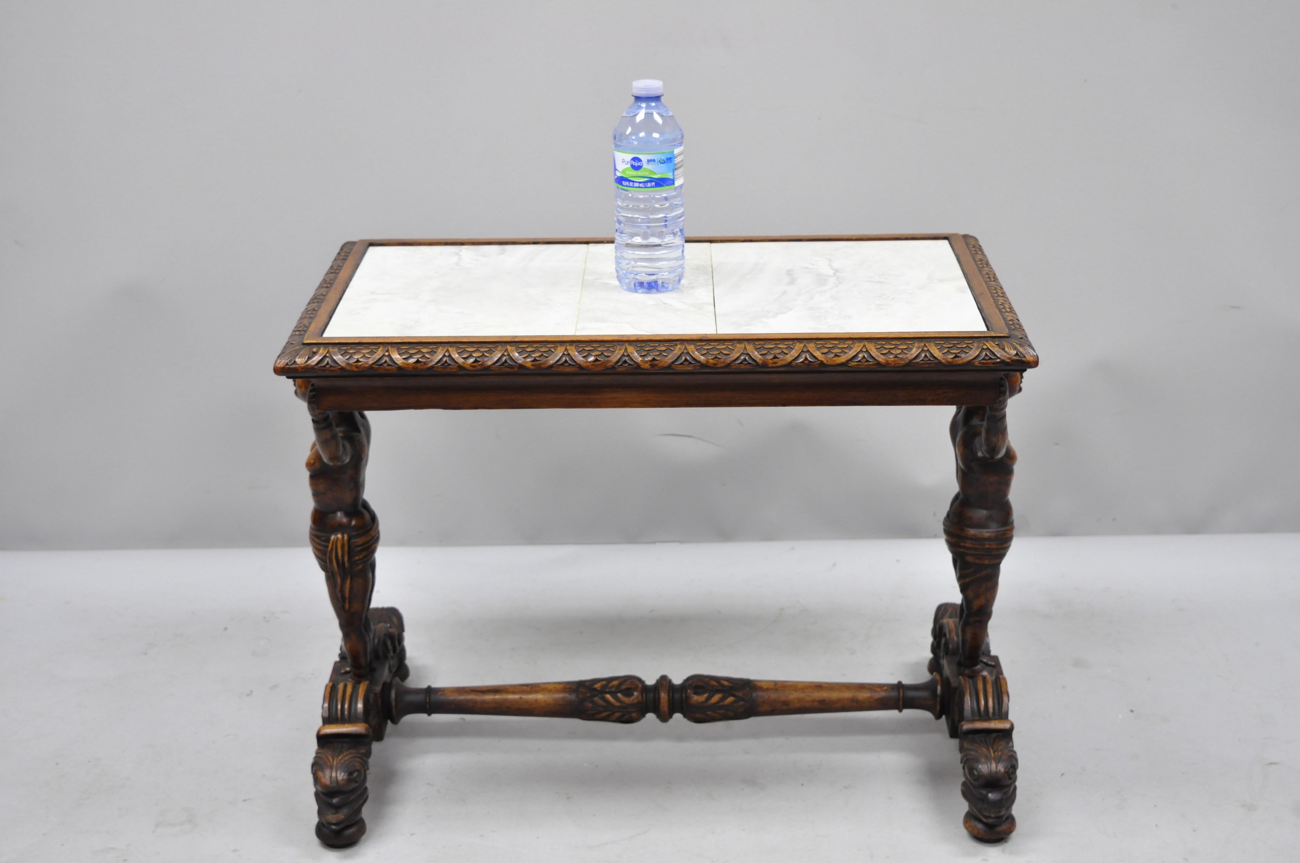 Antique carved full cherub figural Italian Renaissance side table. Item features dolphin carved base, finely carved full figures of putti/cherub/boy supports, removable ceramic tile top, finely carved details, very nice antique item, circa early