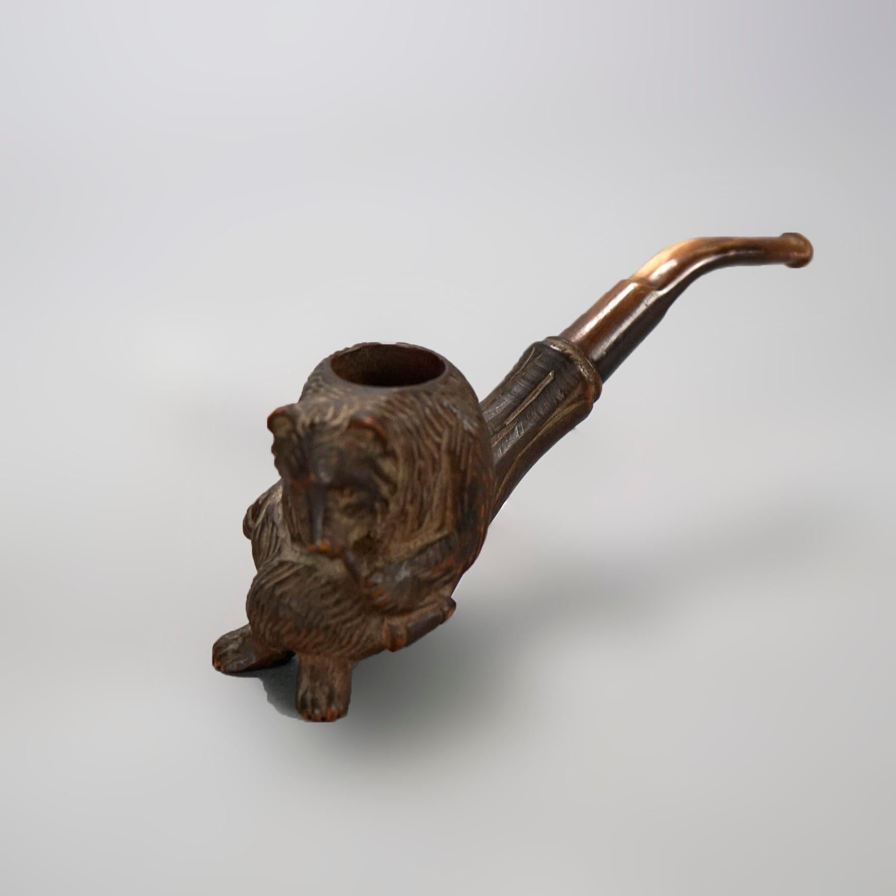 An antique German Black Forest figural tobacco pipe offers carved seated bear bowl, c1920.

Measures- 2.25''H x 1.5''W x 5.75''D.