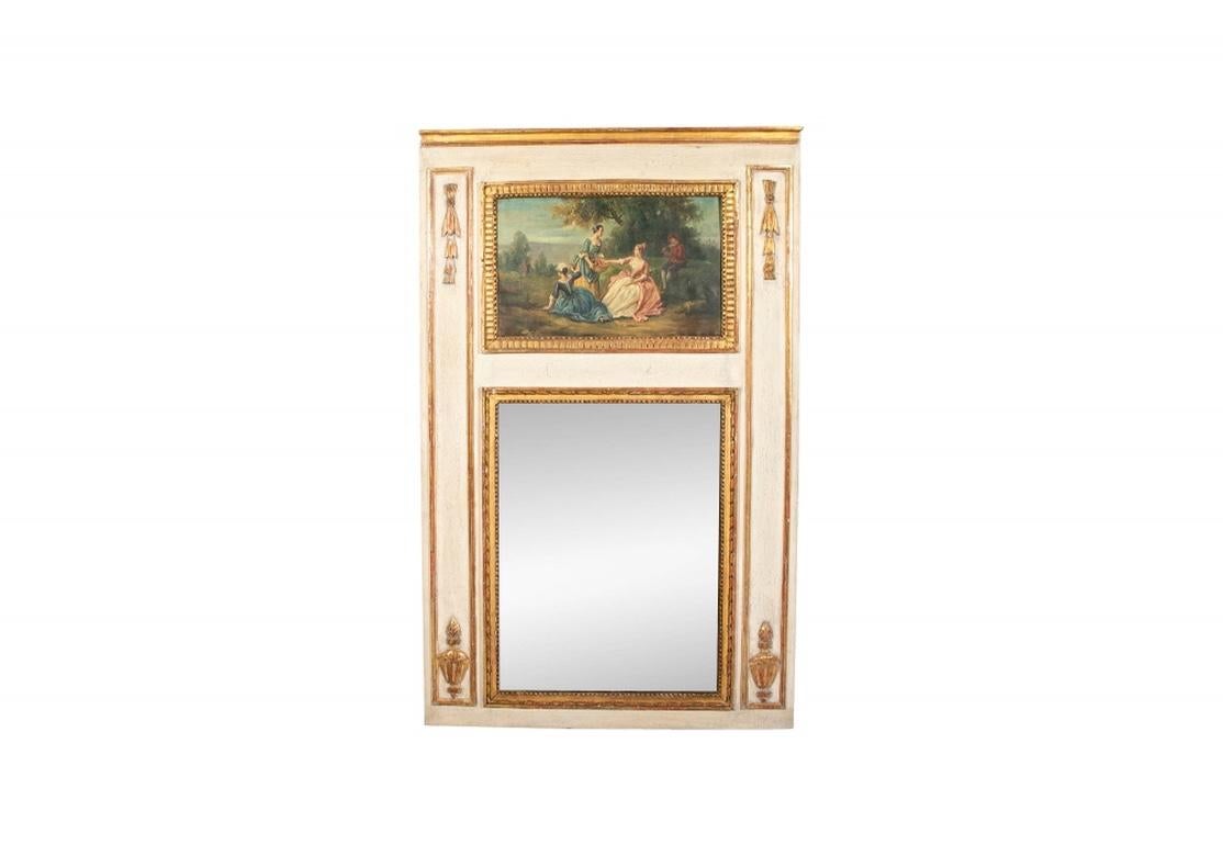 A large antique French carved, painted and gilt trumeau mirror. In off-white paint with applied carved and gilt decoration of pendant leafy upper corner motifs and vasiform ones in the lower corners. The mirror with ribbon twist and beaded surround.