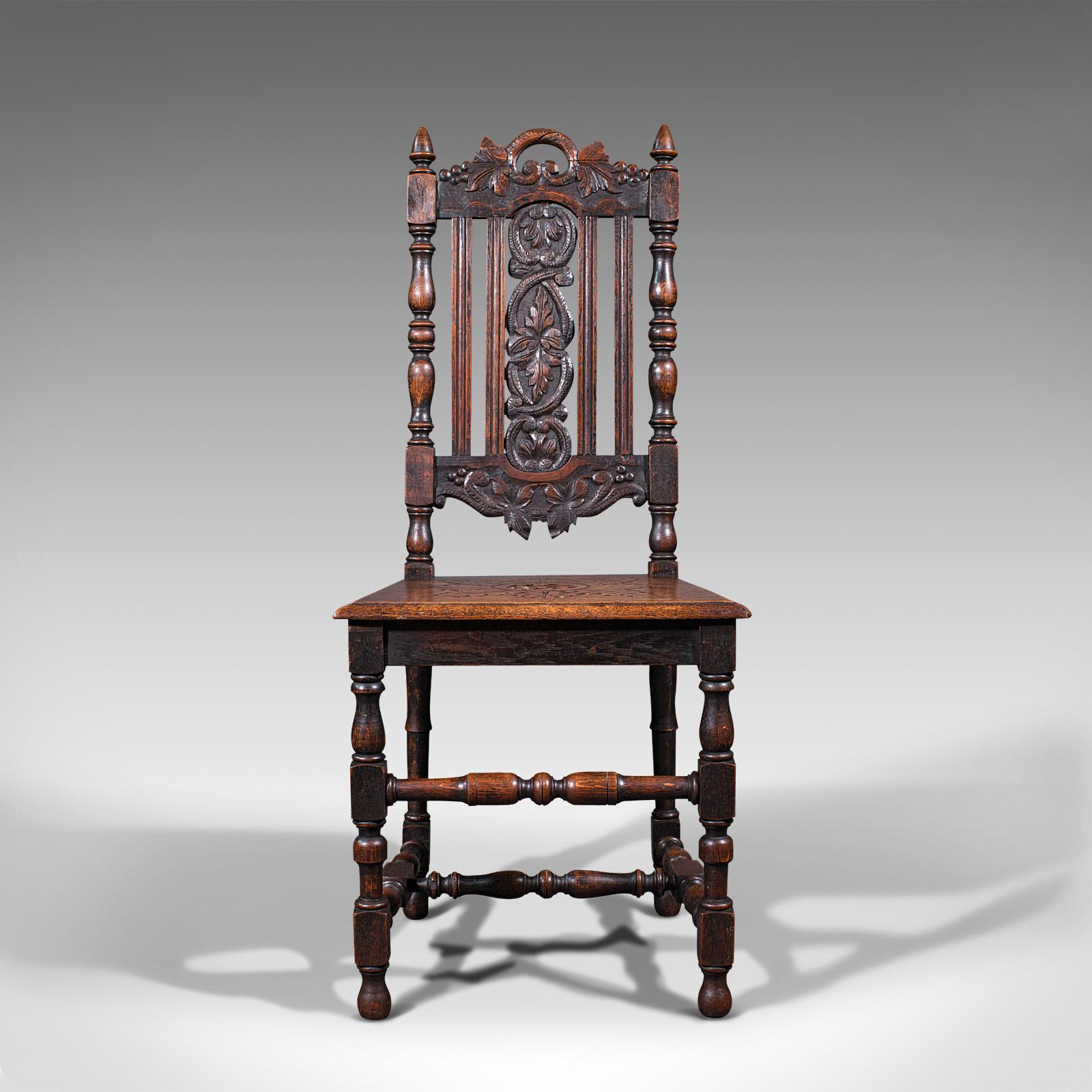 This is a pair of antique carved hall chairs. A Scottish, oak decorative side seat, dating to the Victorian period, circa 1870.

Profusely carved with leaf and foliate detail throughout
Displays a desirable aged patina and in good order
Select