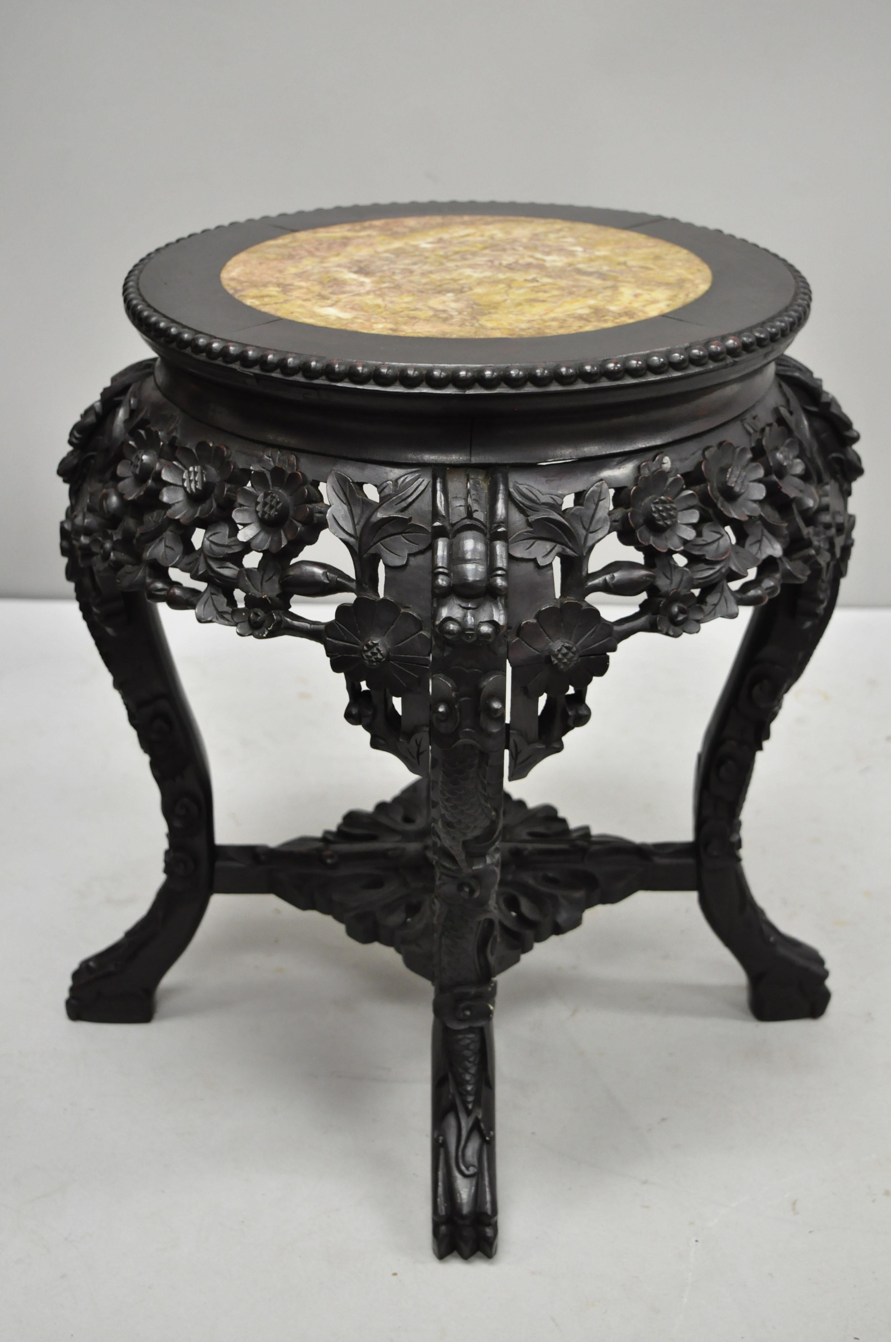 Antique Carved Hardwood Rosewood and Marble Top Chinese Pedestal Table (A). Item features inset marble top, pierce carved floral skirt, carved stretcher base, solid wood construction, finely carved details, very nice antique item. Circa Late 19th to
