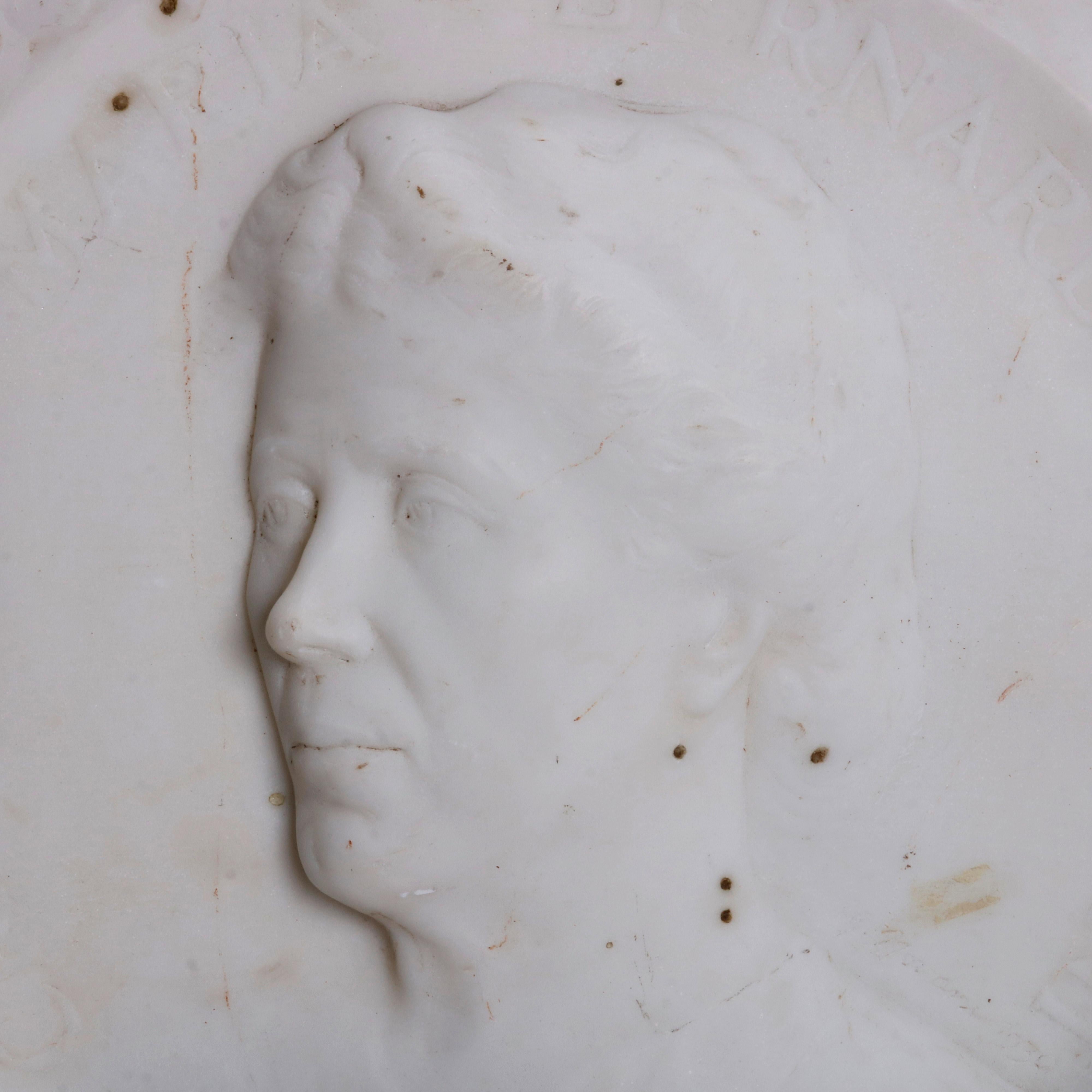 An antique Italian portrait plaque offers carved marble depiction of woman in profile and 
