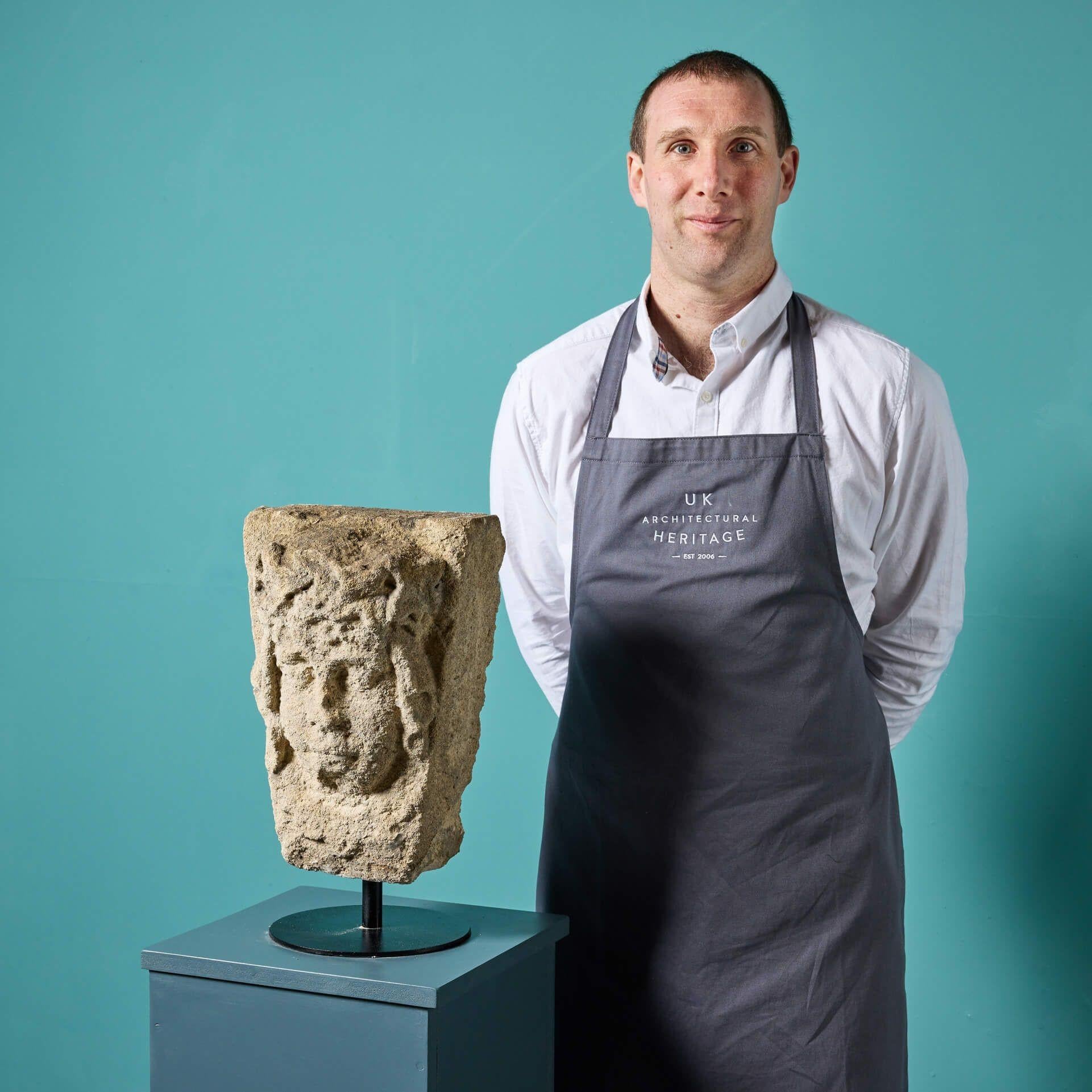 An antique carved limestone keystones of a Queen, salvaged from a period building in East Anglia.

Displayed on a modern steel stand in a sleek black finish, this keystone is an impressive hand-carved sculpture showcasing desirable weathering.

The