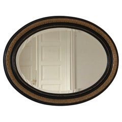 Antique Carved Louis Philippe Oval Mirror In Black and Gold France Late 19th Cen