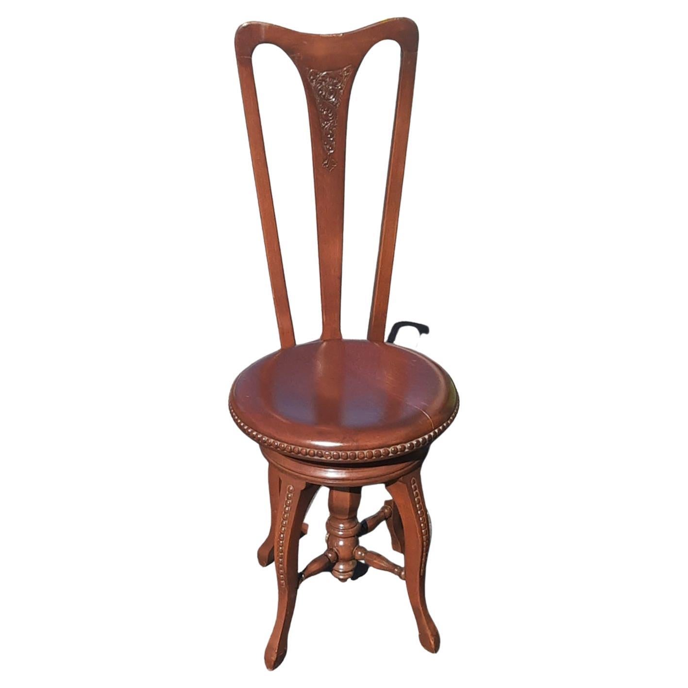 An American music room chair with shaped crested rail, incised with scrolls. Ring turned supports, circular height adjustable seat, turned legs, x-stretcher centered by a turned pillar. Swiveling seat.
Clean and steady antique