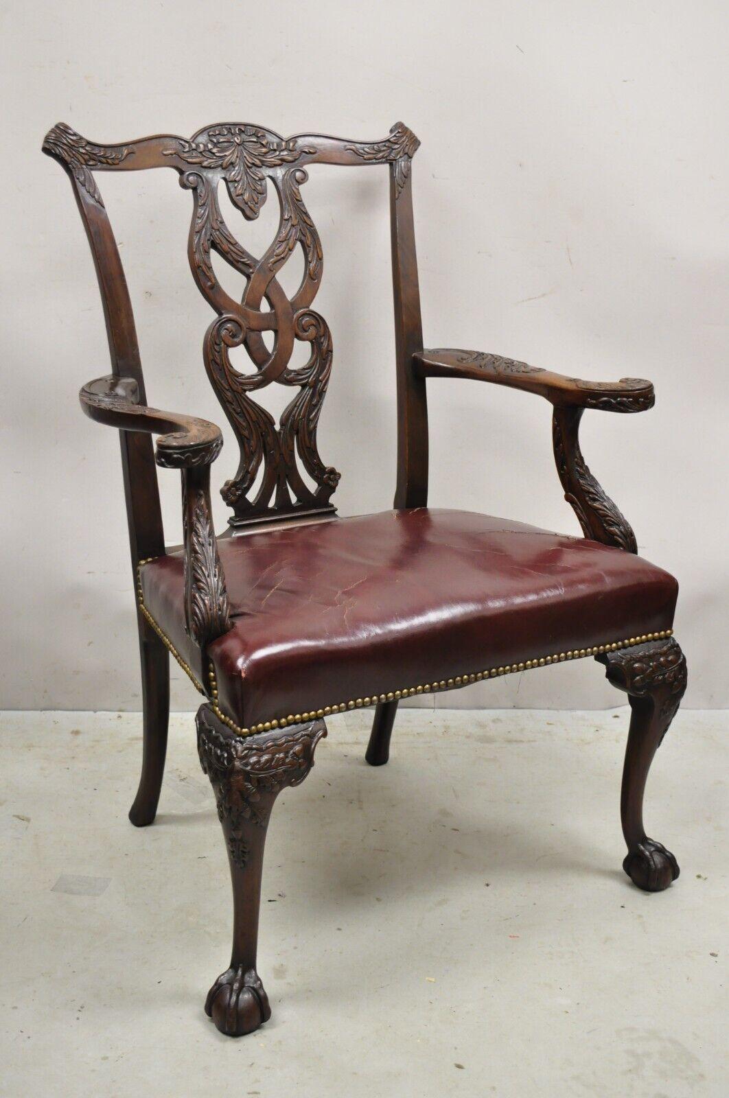 Antique Carved Mahogany Chippendale Style Ball and Claw Leather Arm Chair. Item features a solid mahogany wood frame, nicely carved details, burgundy leather seat, great style and form. Circa Early 1900s. Measurements: 39.5