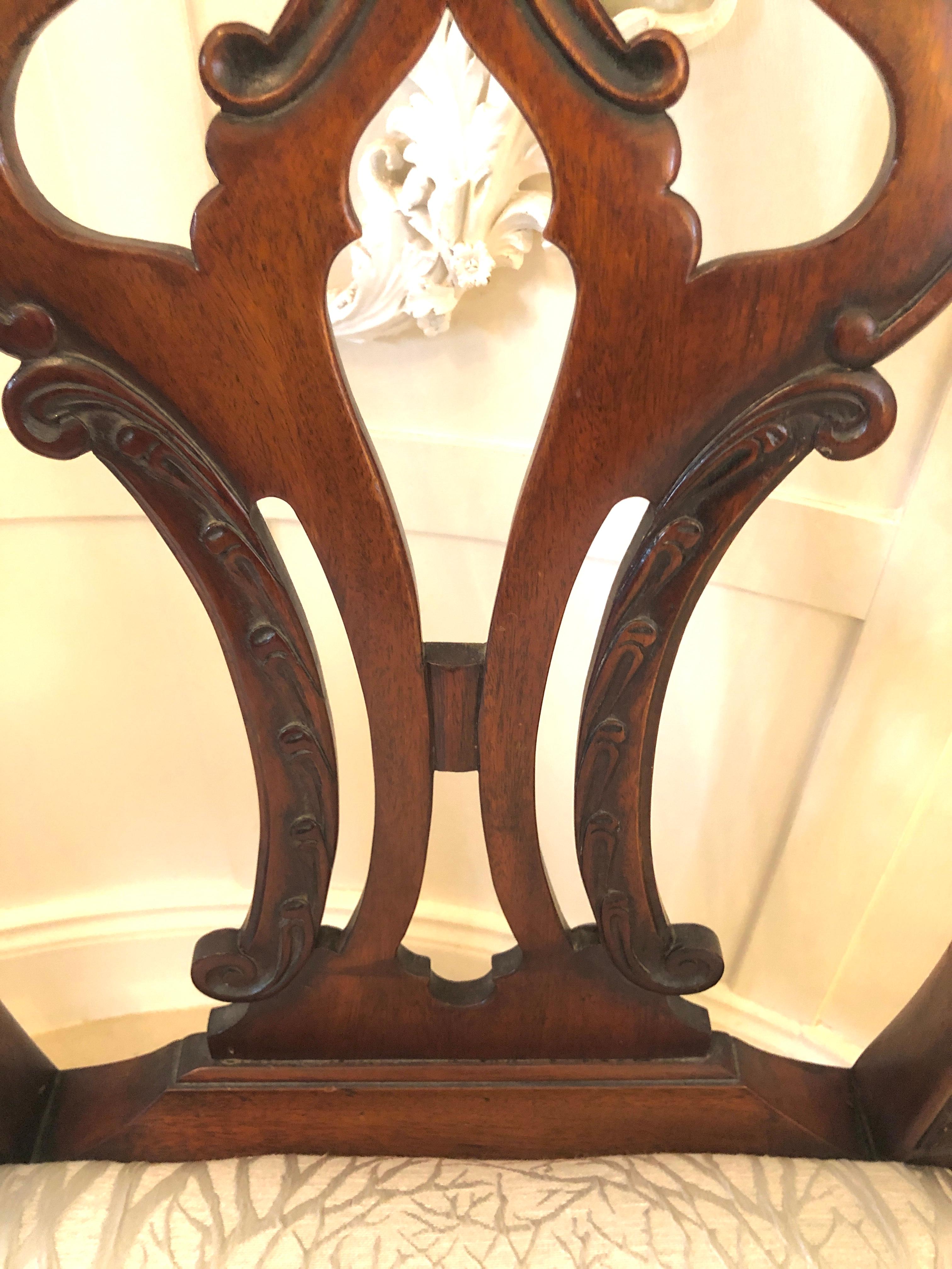 Antique carved mahogany desk chair having a lovely carved mahogany shaped top rail and fantastic carved pierced shaped splat to the centre, carved mahogany shaped open arms, drop in seat which has been newly reupholstered, mahogany frieze standing