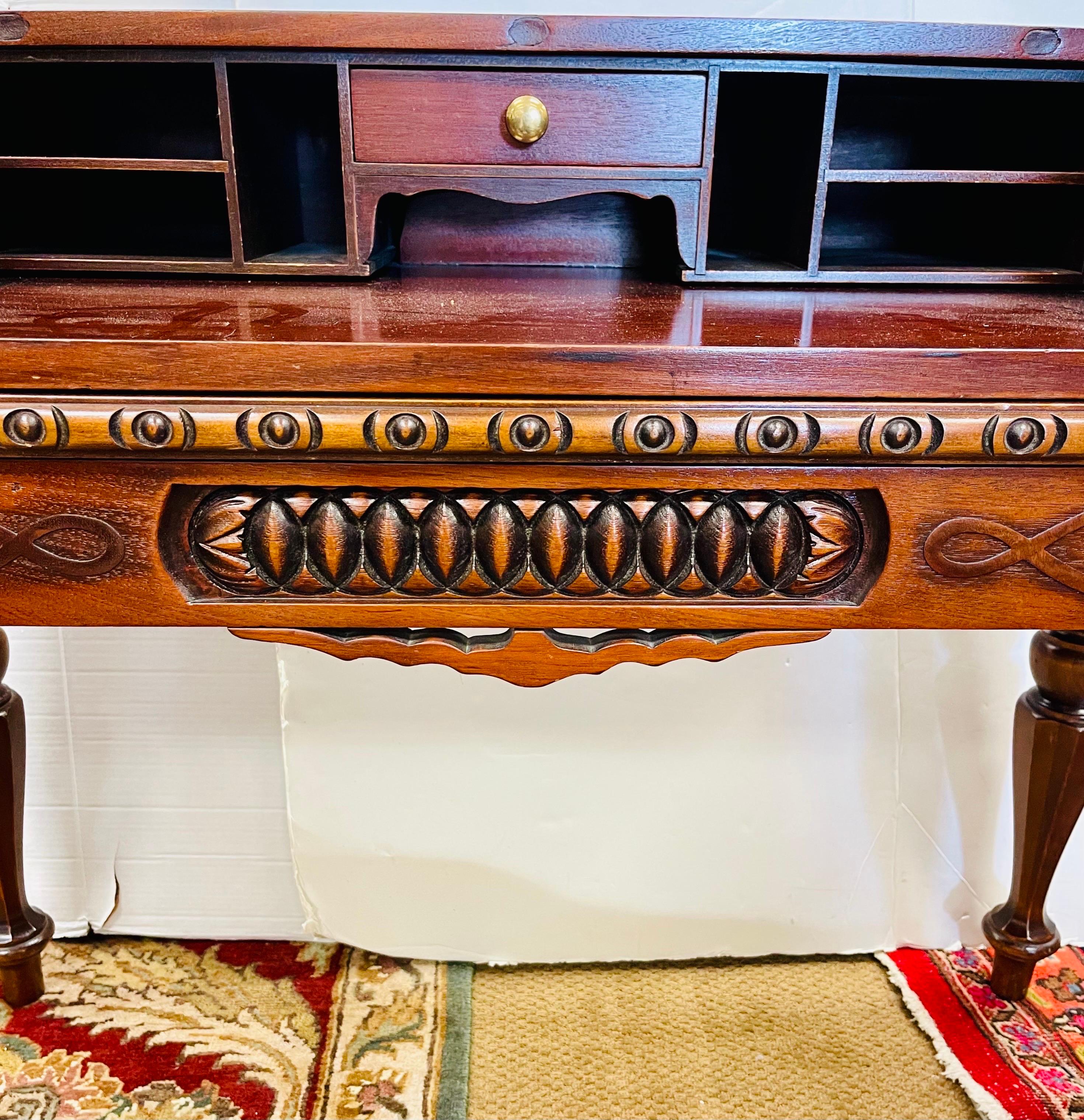Stunning antique heavily carved mahogany desk/writing table from the late 19th century. Note the detail and carvings throughout. All hand carved and features a sliding writing service that pulls out. Smaller scale would look great in a smaller