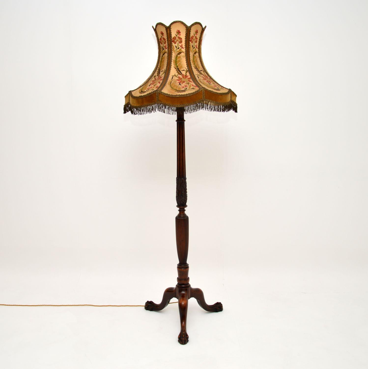 A fabulous antique carved mahogany lamp, with an equally fabulous antique needlepoint shade, dating from around the 1910-20’s period.

This lamp shade is one of the finest we have ever seen, with absolutely amazing hand stitched floral designs. It