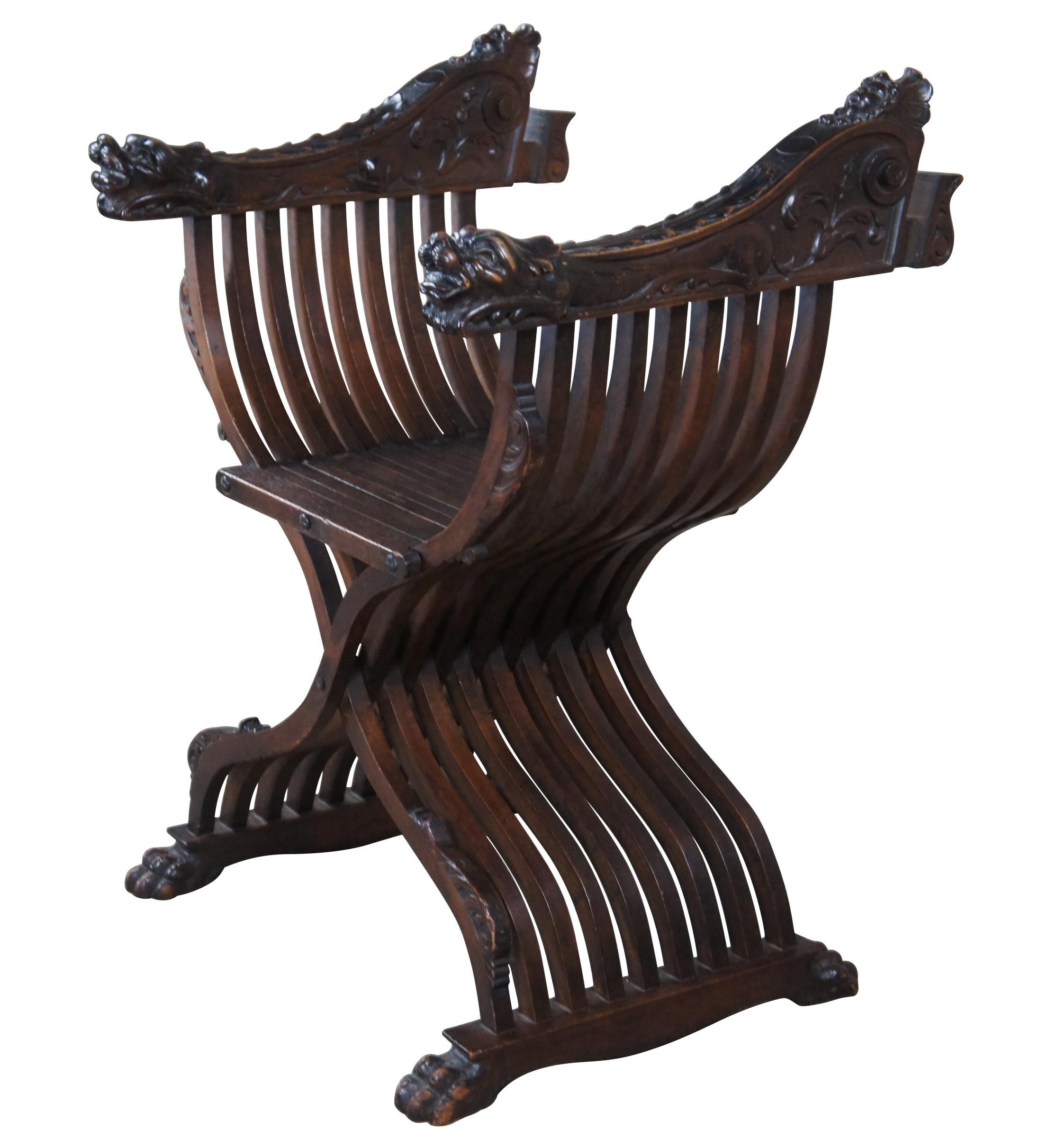 Antique Savonarola mahogany Campaign arm chair. Features a serpentine X frame with dragon / lion head arms featuring a figural female bust by the shoulder between an open back and paw / claw feet.

The Savonarola chair design comes from the