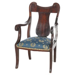 Antiguo sillón de caballero con respaldo de listones de caoba tallada S. XIX