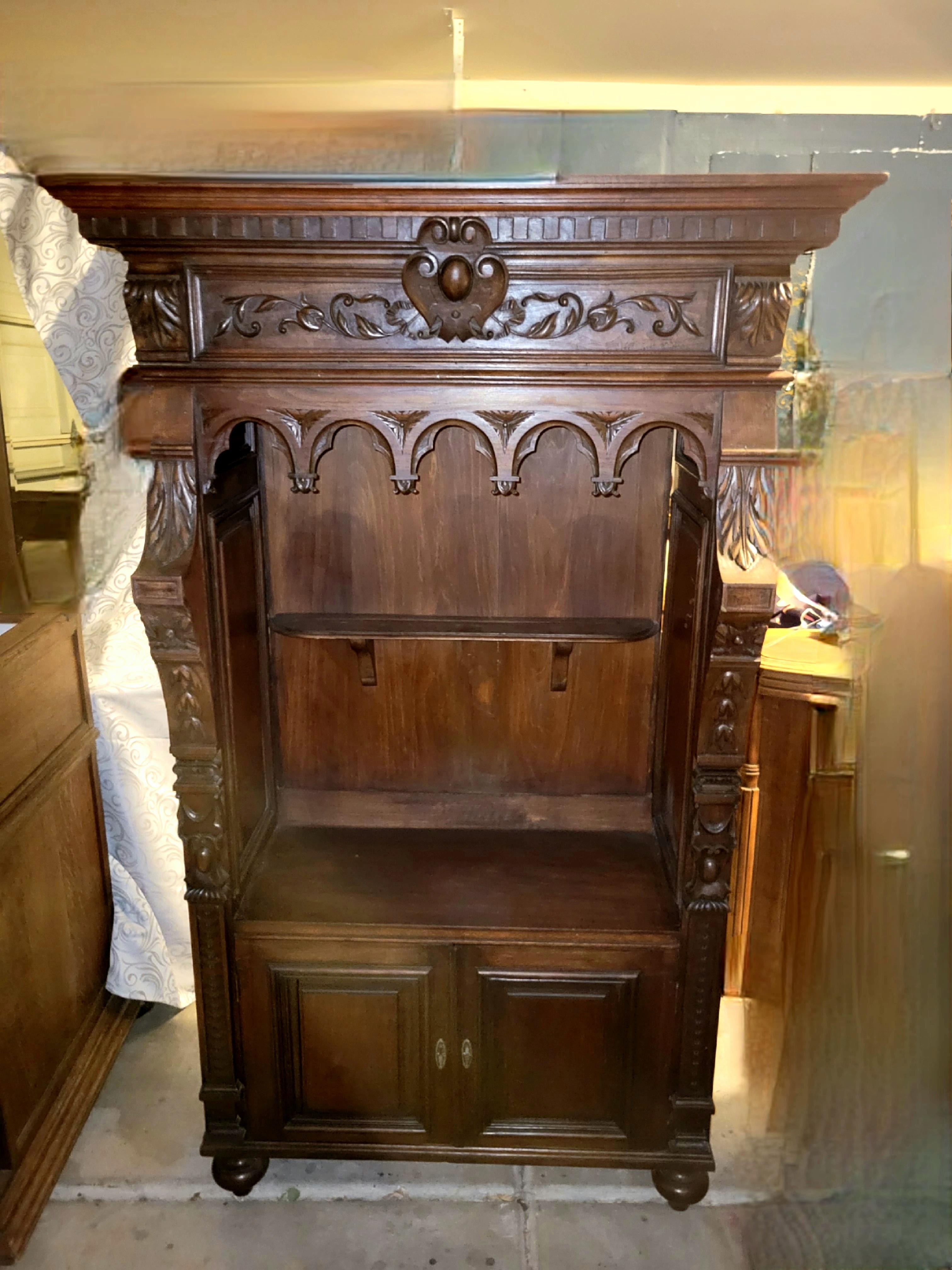Antique hand-carved buffet, plate display, cupboard - 63 x 32 x 16 1/2.  This piece is study and well preserved. 
The buffet has a  25 inch long by 4.5 inch wide horizontal shelf with rounded corners, supported by two corbels. 
A bottom compartment