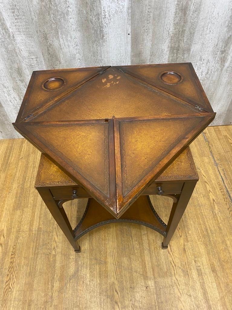 Vintage Theodore Alexander Mahogany Leather Tiered Handkerchief Game Table with 2 Chairs

This set would be perfect as a small dining table, game table or crafting table. The chairs have small round carvings on their legs. The table has four leaves