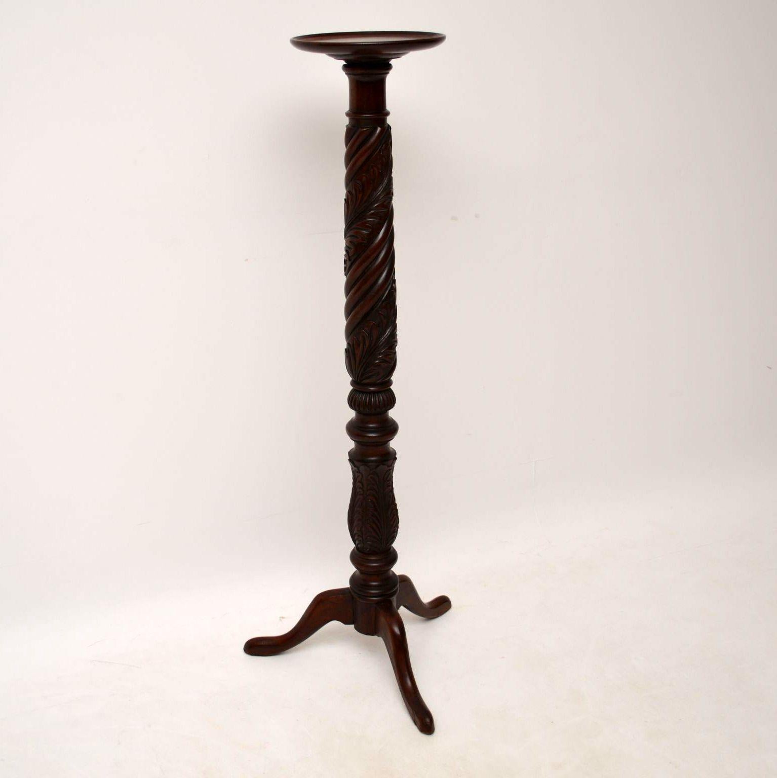 Antique solid mahogany torchere stand with abundant carvings, turnings and designs all down the stem., sitting on tripod legs. It's in excellent original condition and I would date it to circa the 1840 period.

Measures: Width 18?, 46 cm
Height