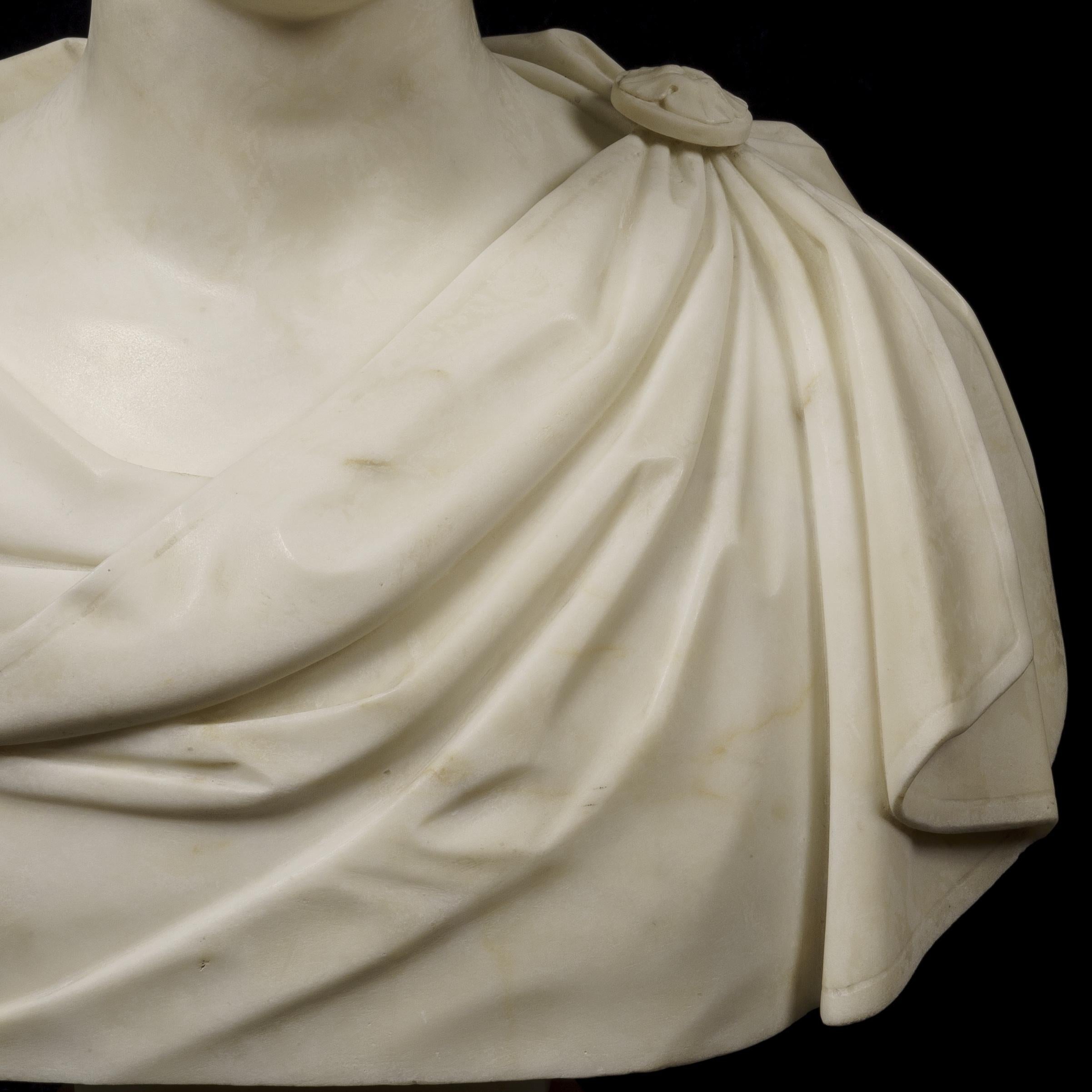 A male portrait bust in the Roman manner by Lawrence MacDonald (1799-1878) Carved in Carrara marble, rising from a round socle supporting a waisted column, the bust having resemblances to Arthur Wellesley, the Duke of Wellington as a young man.