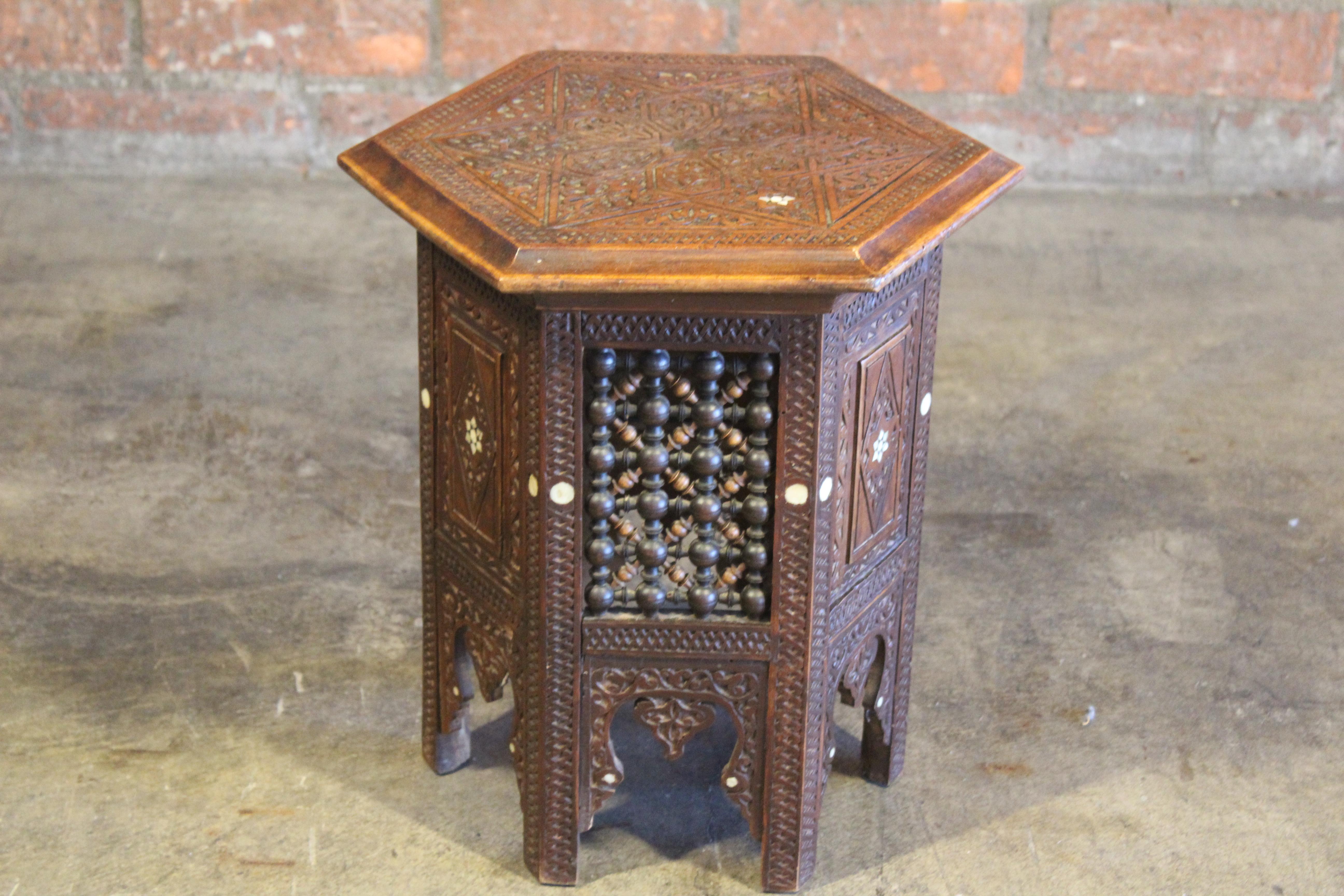 A vintage carved and inlaid Moorish style side table. In good condition with age appropriate wear.