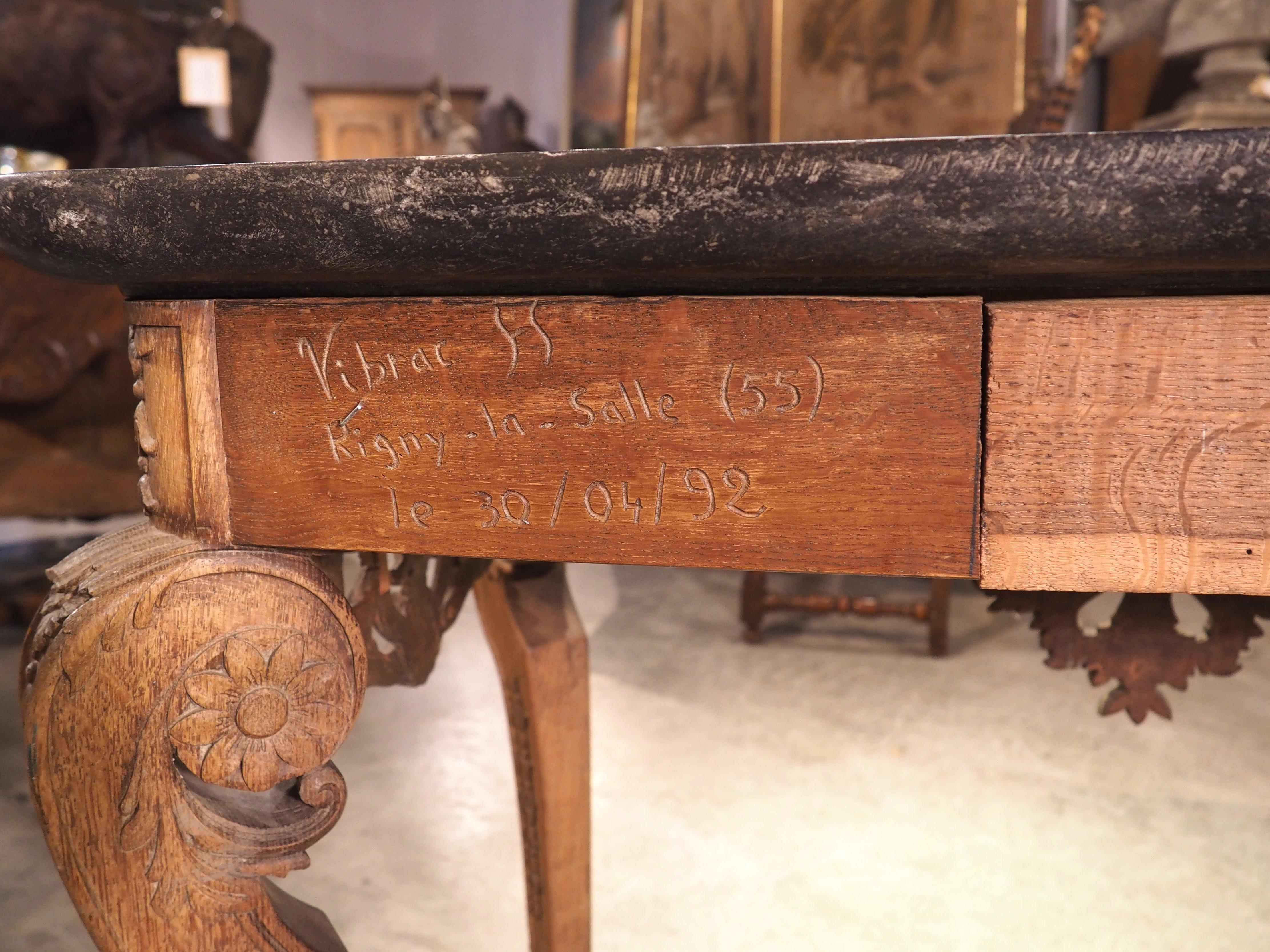 Hand-carved circa 1850 in the northern reaches of France, known as French Flanders, this oak console or “table a Gibier” has a lovely black bluestone top with white and gray veining. The 1 ½ inch thick top, which has an inverted quarter-round