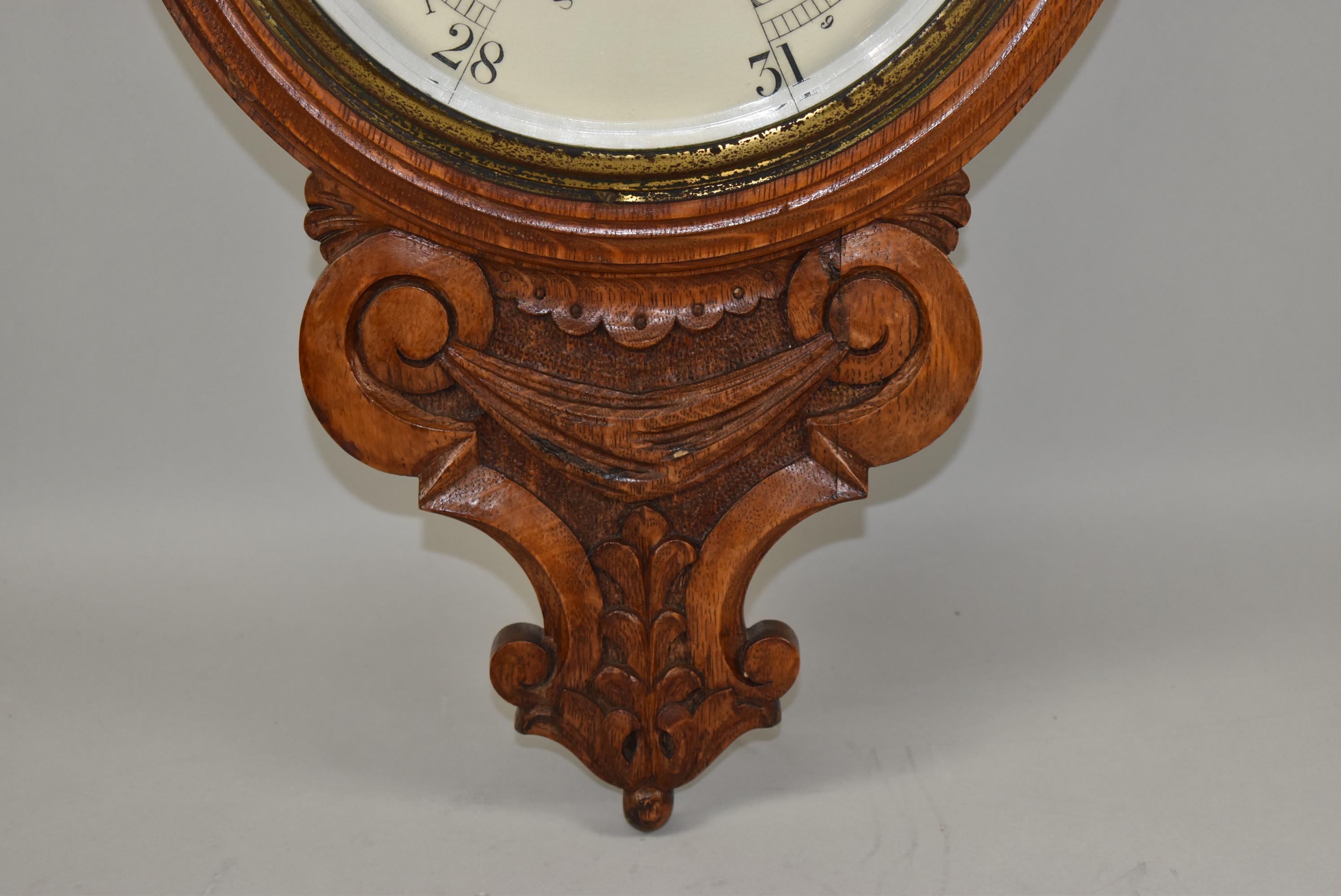 Antique oak carved barometer by Lloyd, Payne & Amiel Manchester England. Thermometer mounted above opening. Porcelain dial. Operating condition. Beveled glass in a brass bezel. Very nice to excellent condition. Dimensions: 3