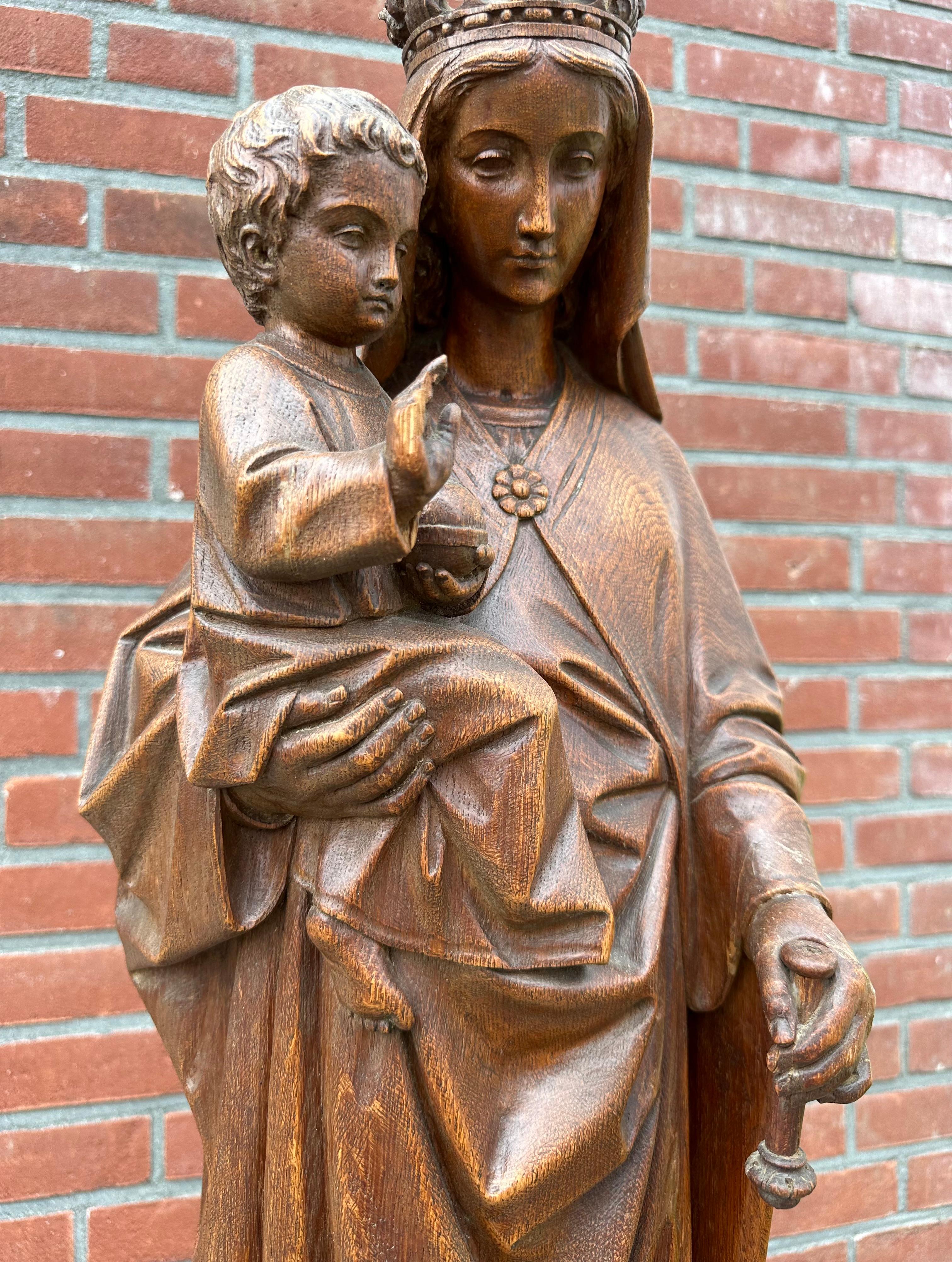 Beautiful set of an antique Holy Mary and Christ with original pedestal.

This finely hand carved wooden sculpture of our Holy Mary with the child Jesus on her arm is standing on an equally beautiful Gothic church pedestal. These stunning church