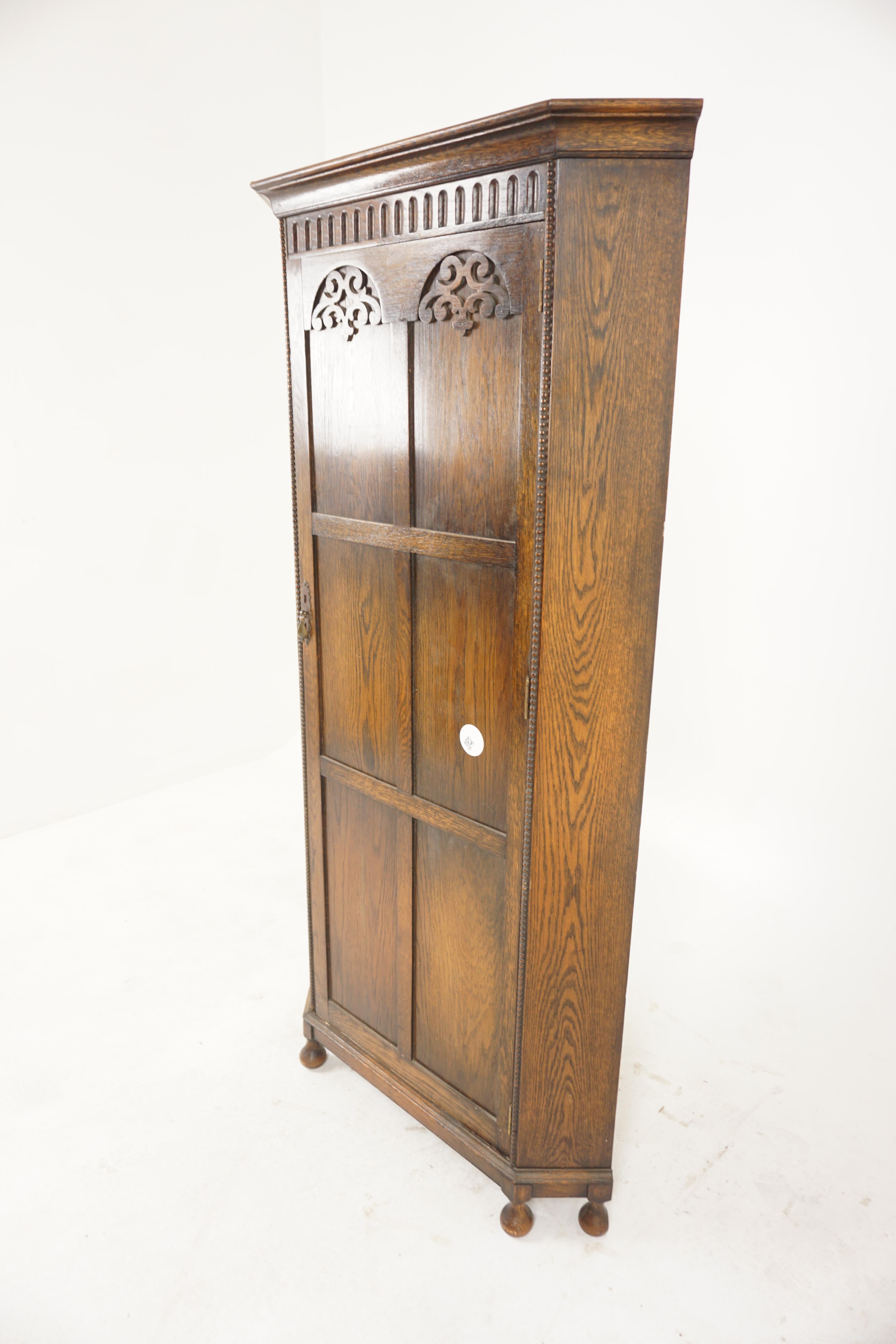 Antique Carved Oak Corner Hall Armoire Wardrobe Closet, Scotland 1910, H1028 

Scotland 1910
Solid Oak
Original finish
Shaped moulded cornice
Thumbnail edging on the front
Flanked by canted corners
Single six panelled door opens to reveal brass coat