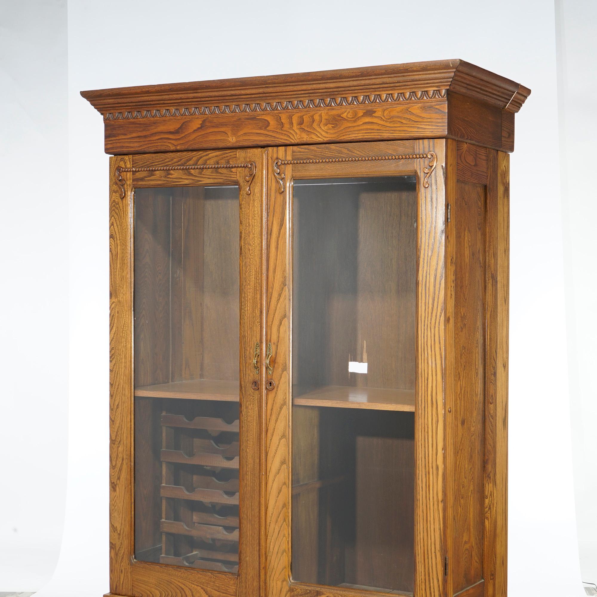 American Antique Carved Oak Double Door Bookcase with Wine Rack c1920 For Sale