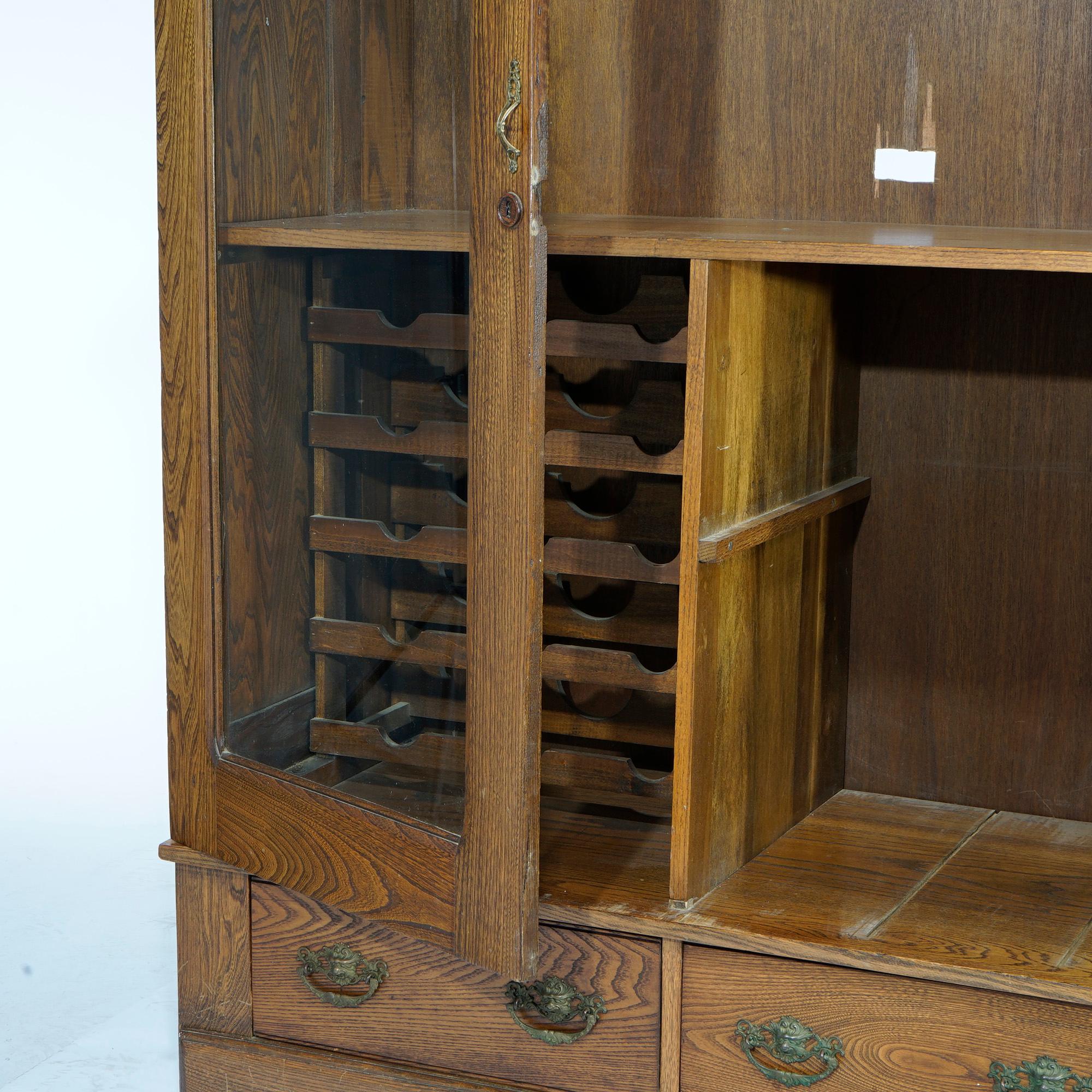 20th Century Antique Carved Oak Double Door Bookcase with Wine Rack c1920 For Sale